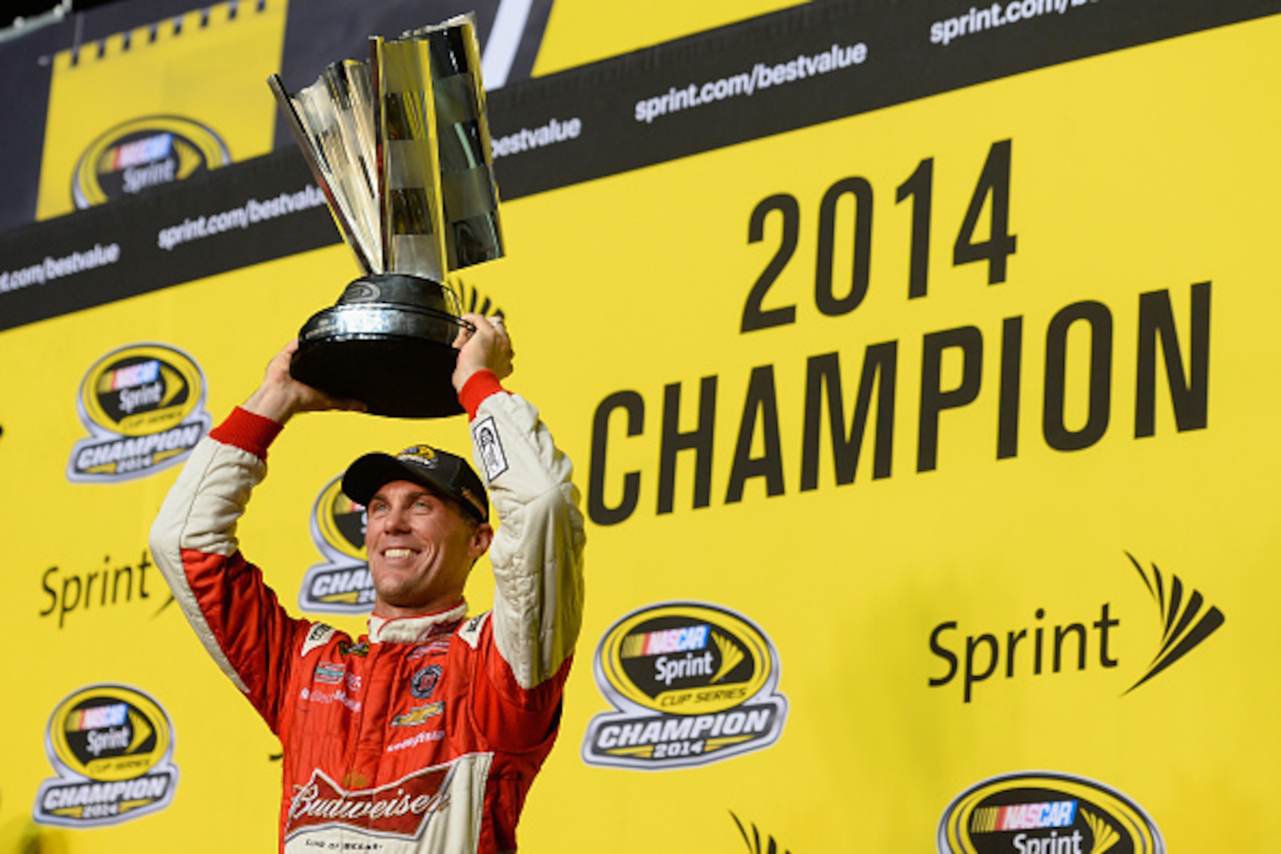 HOMESTEAD, FL - NOVEMBER 16:  Kevin Harvick, driver of the #4 Budweiser Chevrolet, celebrates with the trophy in victory lane after winning the NASCAR Sprint Cup Series Ford EcoBoost 400 at Homestead-Miami Speedway on November 16, 2014 in Homestead, Flori