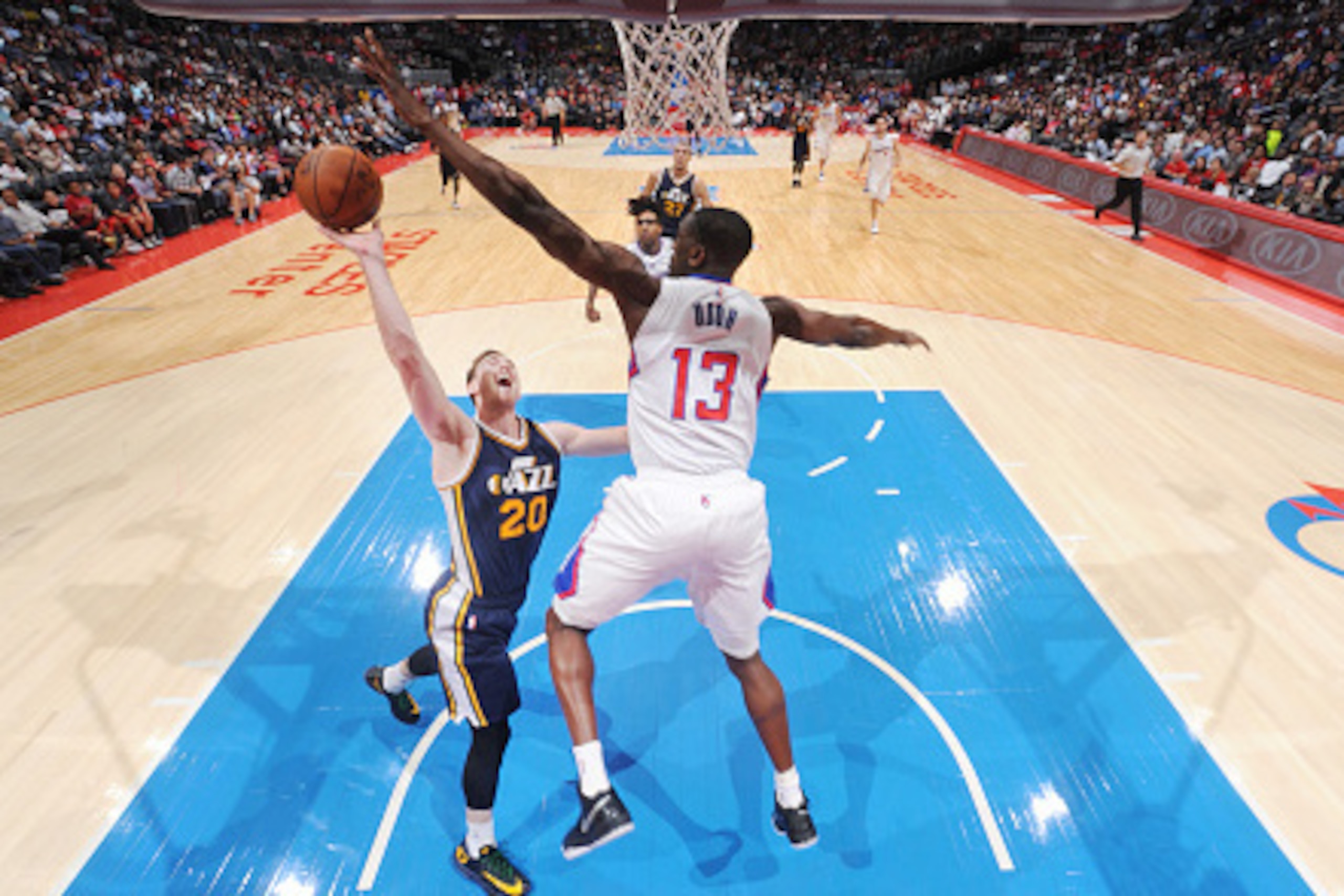 LOS ANGELES, CA - OCTOBER 17: Gordon Hayward #20 of the Utah Jazz goes for the lay up against the Ekpe Udoh #13 of the Los Angeles Clippers during the game at the STAPLES Center on October 17, 2014 in Los Angeles, California. NOTE TO USER: User expressly 