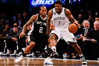 NEW YORK, NY - DECEMBER 03: Kawhi Leonard #2 of the San Antonio Spurs guards Joe Johnson #7 of the Brooklyn Nets at the Barclays Center on December 3, 2014 in the Brooklyn borough of New York City. NOTE TO USER: User expressly acknowledges and agrees that