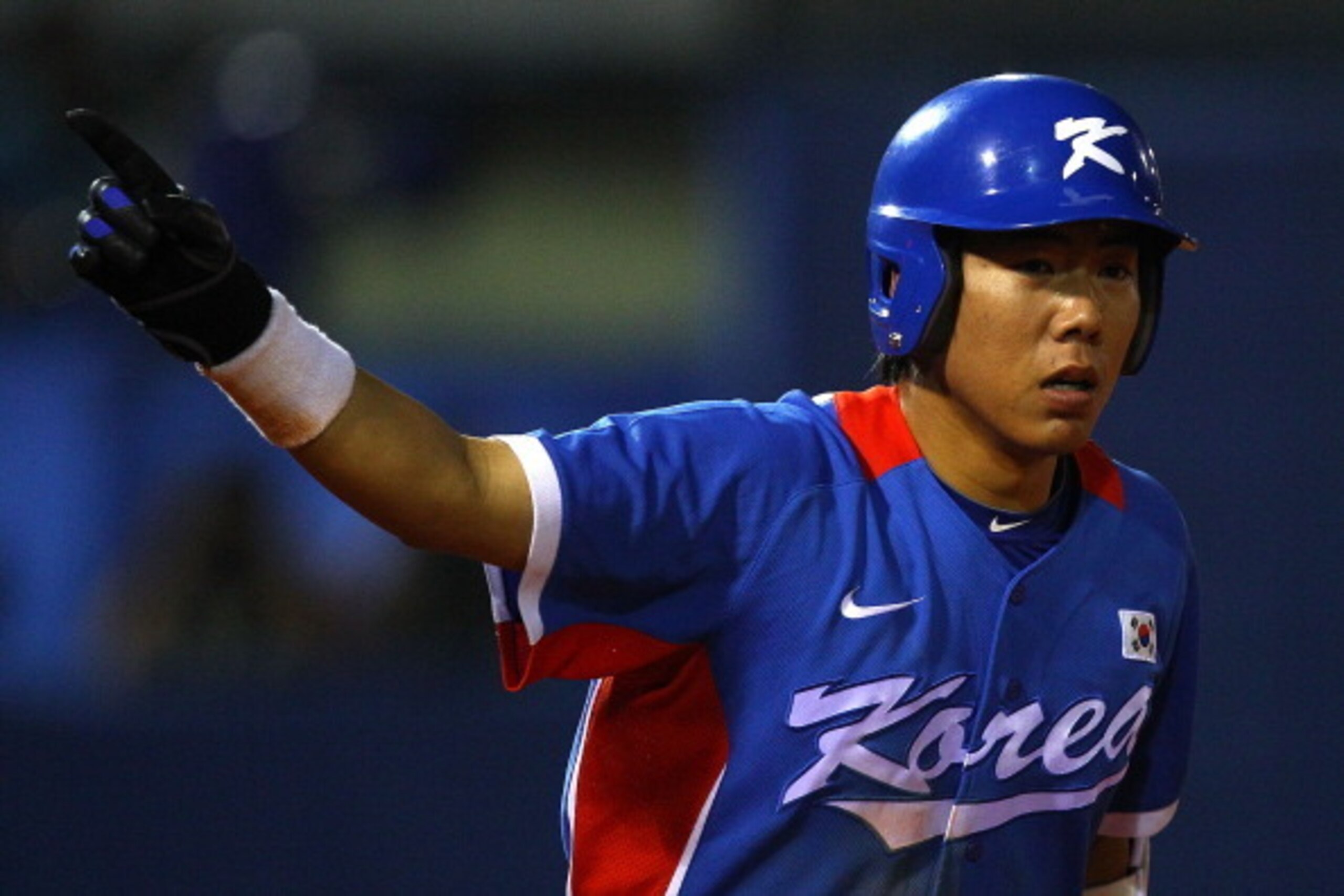 GUANGZHOU, CHINA - NOVEMBER 19:  Jungho Kang #16 of South Korea points after hitting a home run against Chinese Taipei during the gold medal baseball game at Aoti Baseball Field 1 during day seven of the 16th Asian Games Guangzhou 2010 on November 19, 201