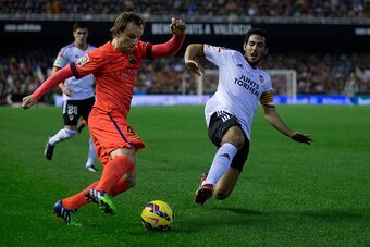VALENCIA, SPAIN - NOVEMBER 30: Ivan Rakitic (L) of FC Barcelona competes for the ball with Dani Parejo (R) of Valencia CF  during the La Liga match between Valencia CF and FC Barcelona at Estadi de Mestalla on November 30, 2014 in Valencia, Spain.  (Photo