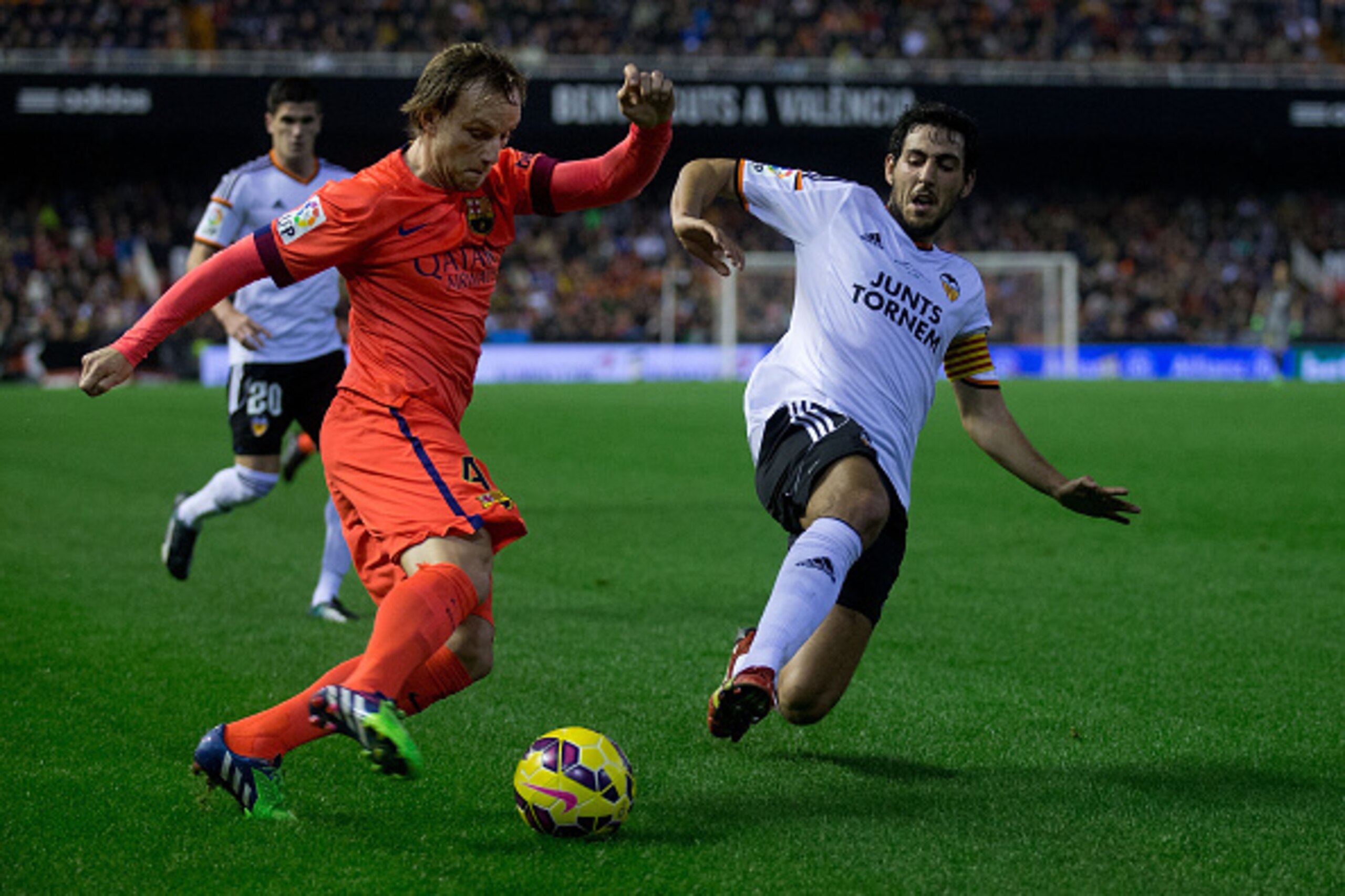 VALENCIA, SPAIN - NOVEMBER 30: Ivan Rakitic (L) of FC Barcelona competes for the ball with Dani Parejo (R) of Valencia CF  during the La Liga match between Valencia CF and FC Barcelona at Estadi de Mestalla on November 30, 2014 in Valencia, Spain.  (Photo