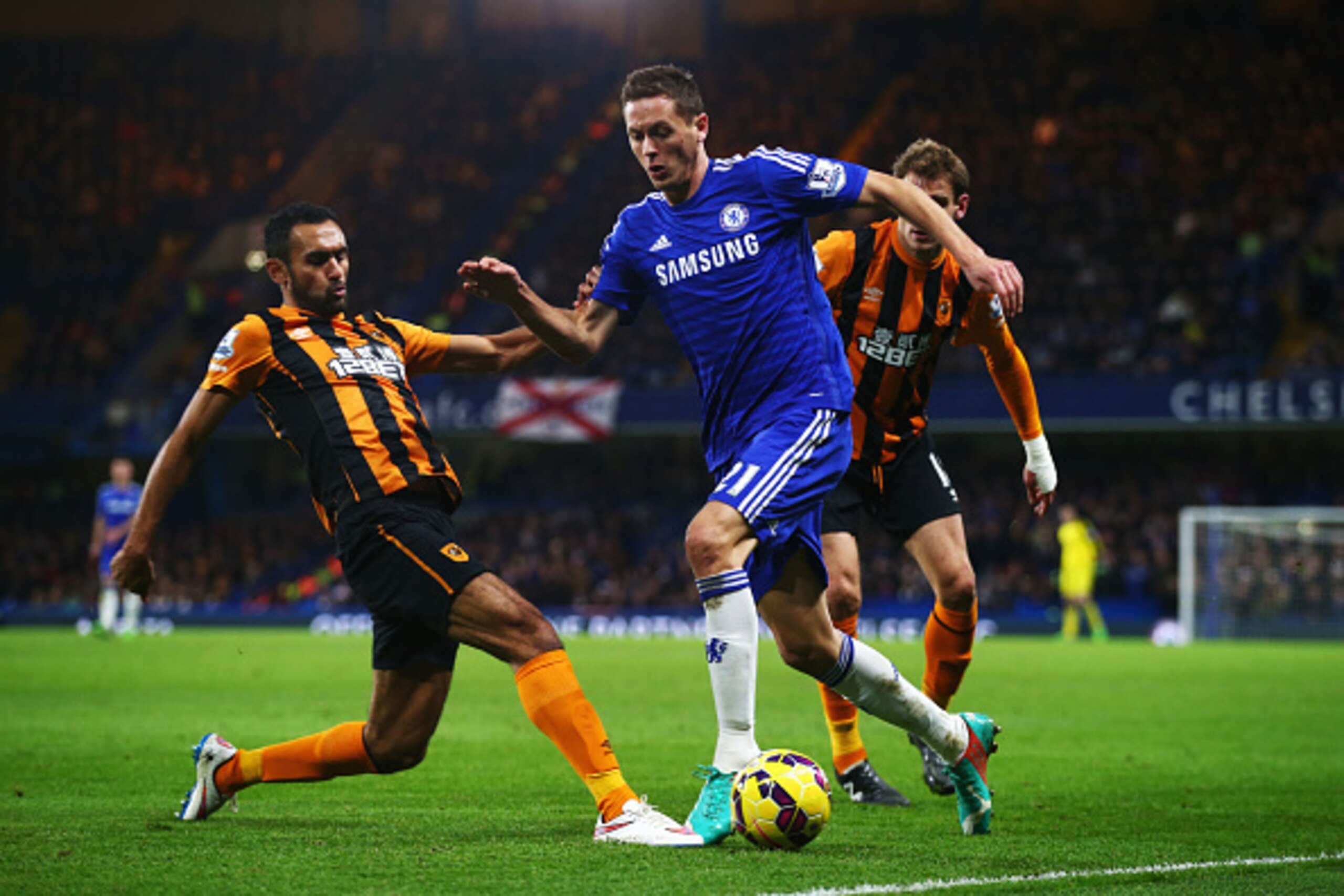 LONDON, ENGLAND - DECEMBER 13:  Nemanja Matic of Chelsea is tackled by Ahmed Elmohamady of Hull City during the Barclays Premier League match between Chelsea and Hull City at Stamford Bridge on December 13, 2014 in London, England.  (Photo by Clive Rose/G
