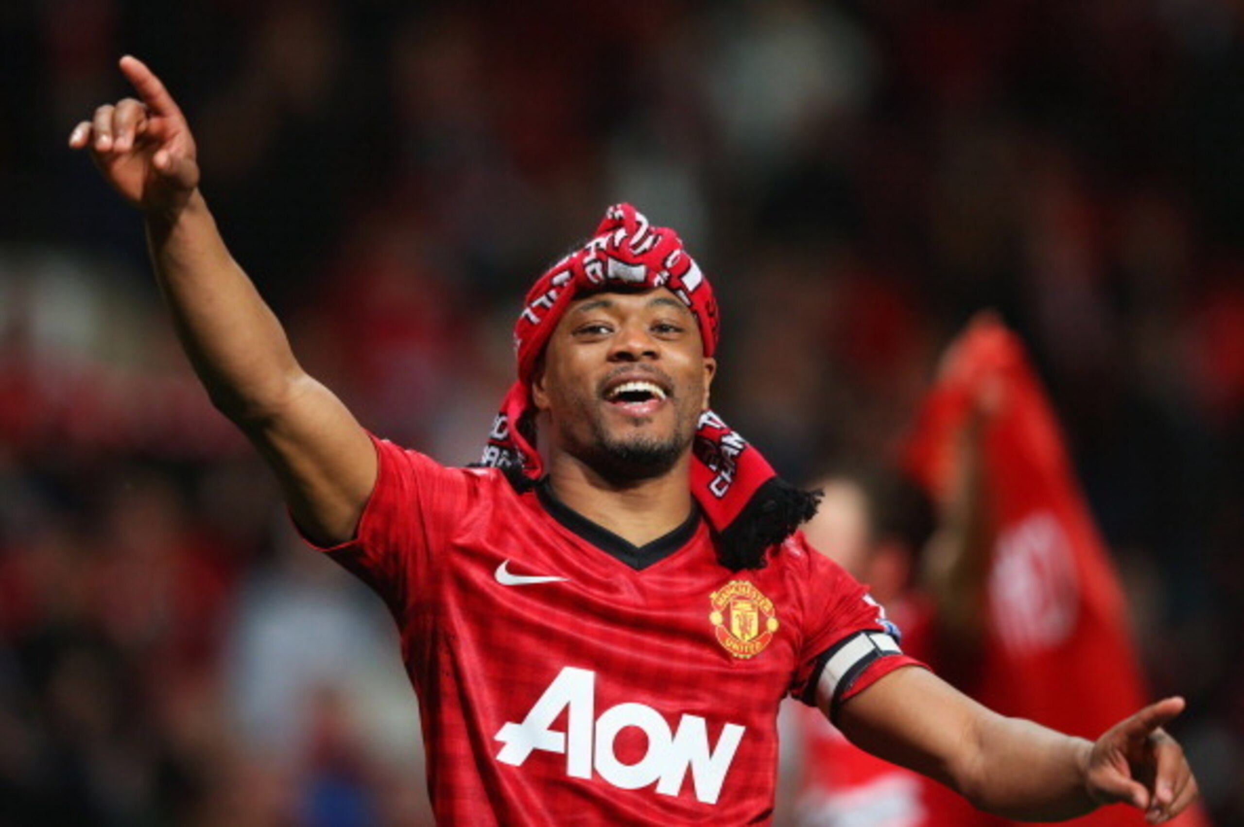 MANCHESTER, ENGLAND - APRIL 22:  Patrice Evra of Manchester United celebrates victory and winning the Premier League title after the Barclays Premier League match between Manchester United and Aston Villa at Old Trafford on April 22, 2013 in Manchester, E