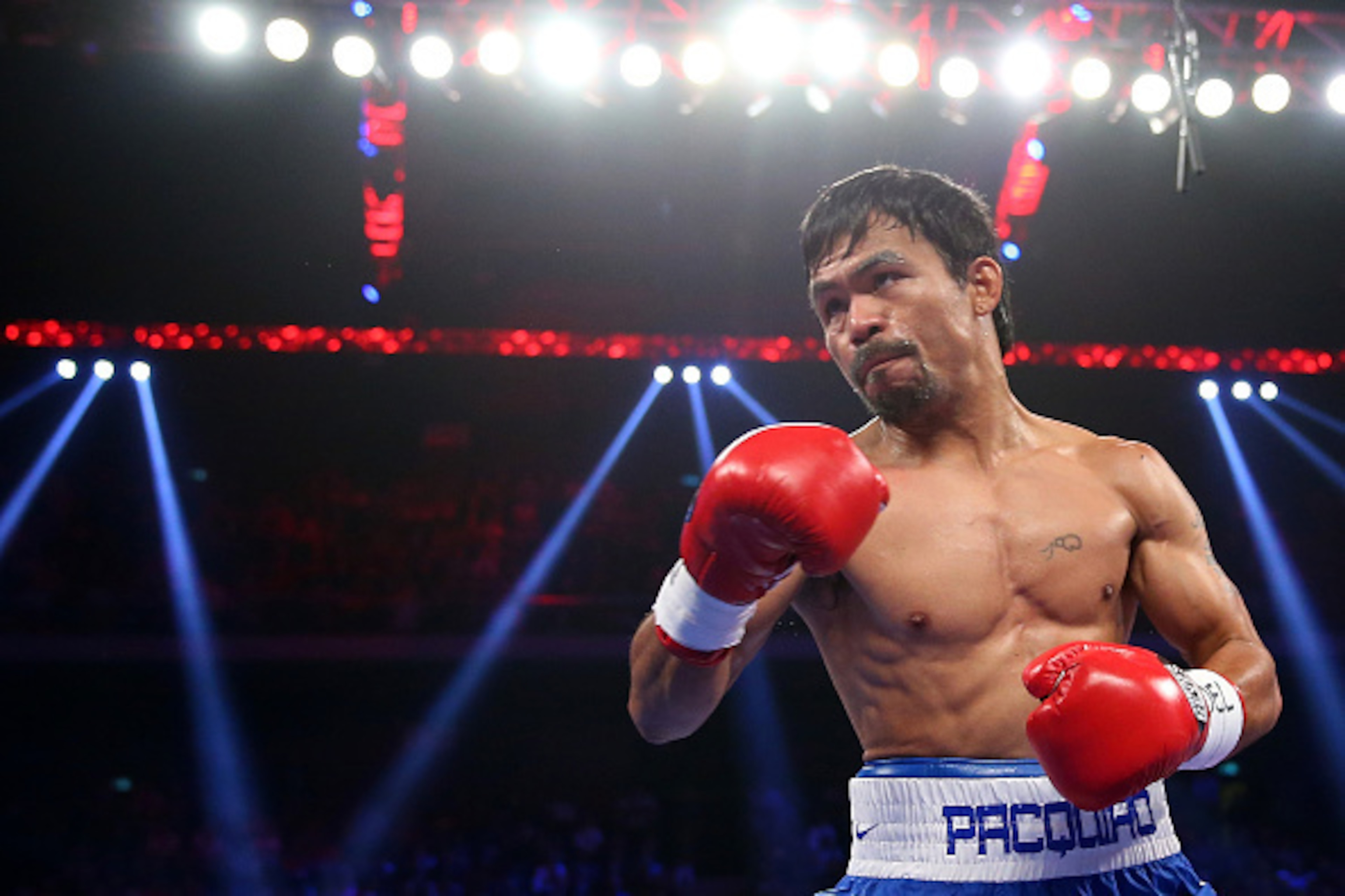 MACAU - NOVEMBER 23:  Manny Pacquiao of the Philippines punches Chris Algieri of the United States during the WBO world welterweight title at The Venetian on November 23, 2014 in Macau, Macau.  (Photo by Chris Hyde/Getty Images)