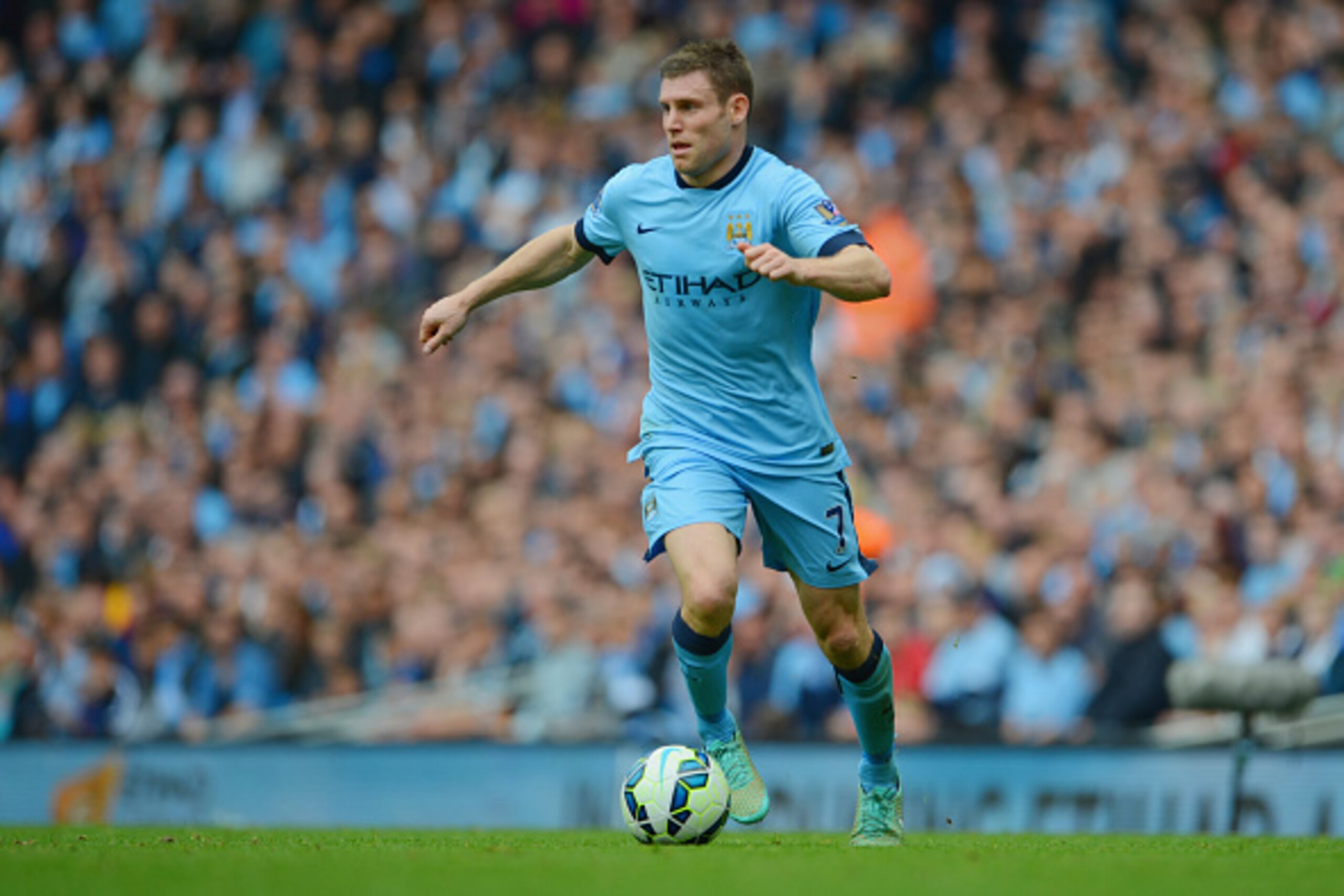 MANCHESTER, ENGLAND - OCTOBER 18:  James Milner of Manchester City in action during the Barclays Premier League match between Manchester City and Tottenham Hotspur at the Etihad Stadium on October 18, 2014 in Manchester, England.  (Photo by Michael Regan/