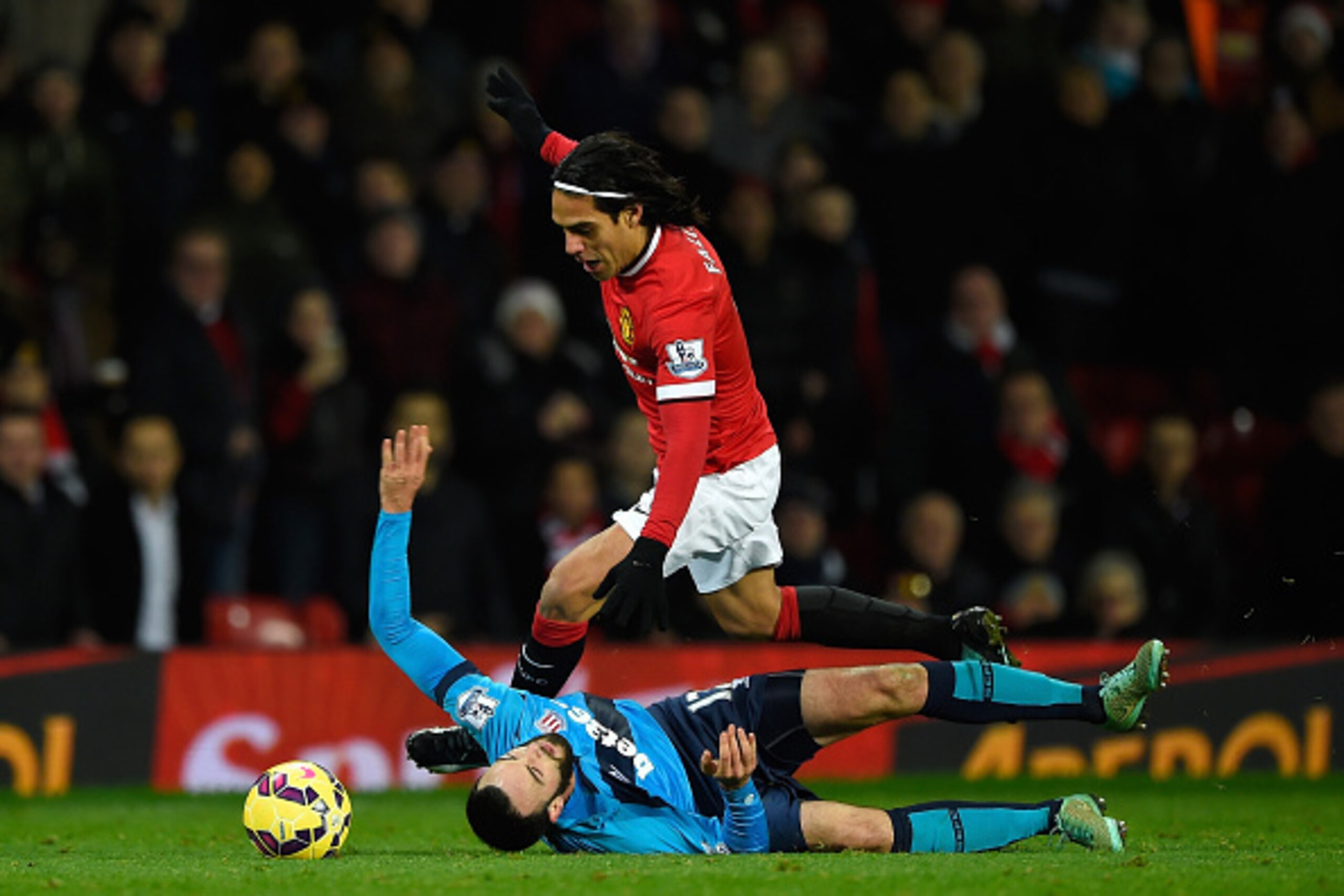 MANCHESTER, ENGLAND - DECEMBER 02:  Radamel Falcao of Manchester United is challenged by Marc Wilson of Stoke City during the Barclays Premier League match between Manchester United and Stoke City at Old Trafford on December 2, 2014 in Manchester, England