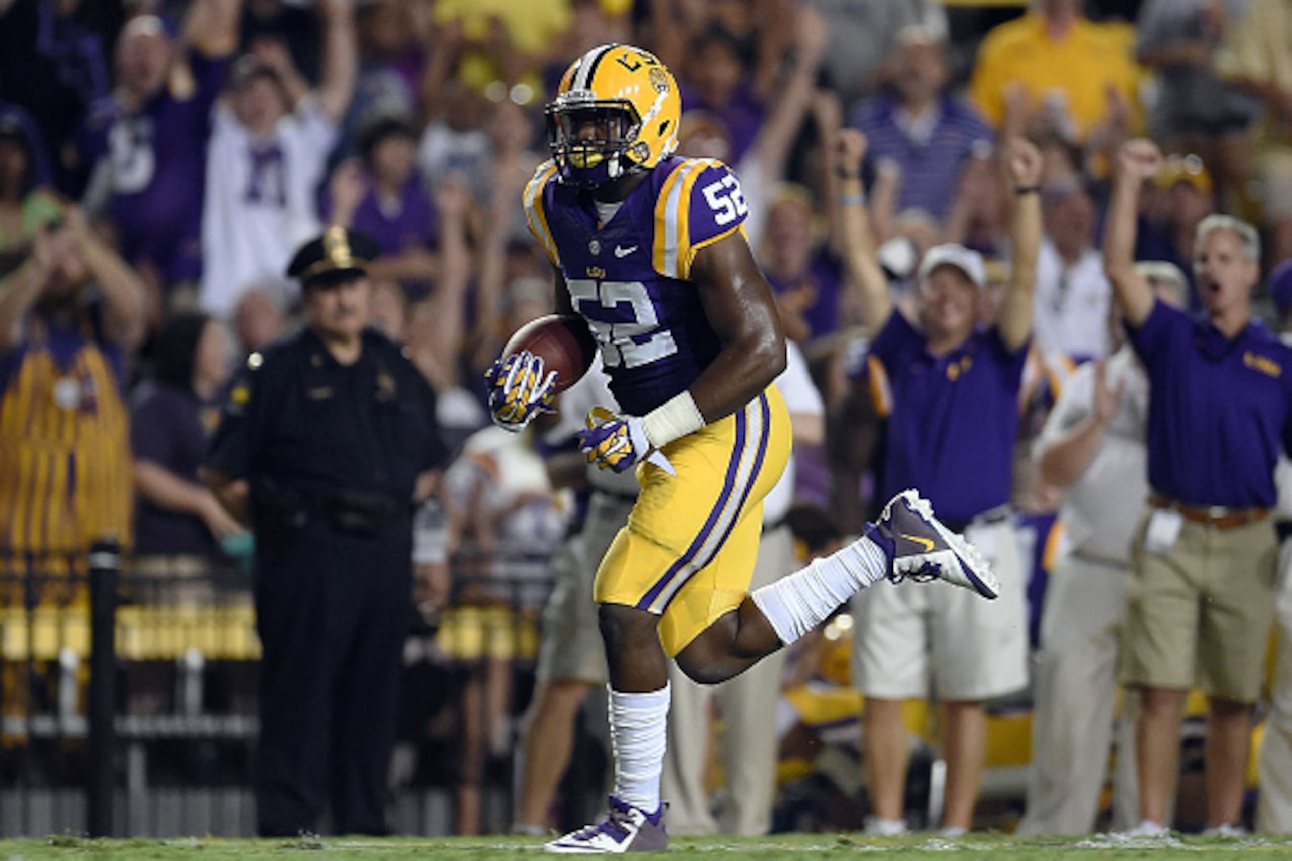 BATON ROUGE, LA - SEPTEMBER 27:  Kendell Beckwith #52 of the LSU Tigers runs for a touchdown following a turnover during the first quarter of a game against the New Mexico State Aggies at Tiger Stadium on September 27, 2014 in Baton Rouge, Louisiana.  (Ph