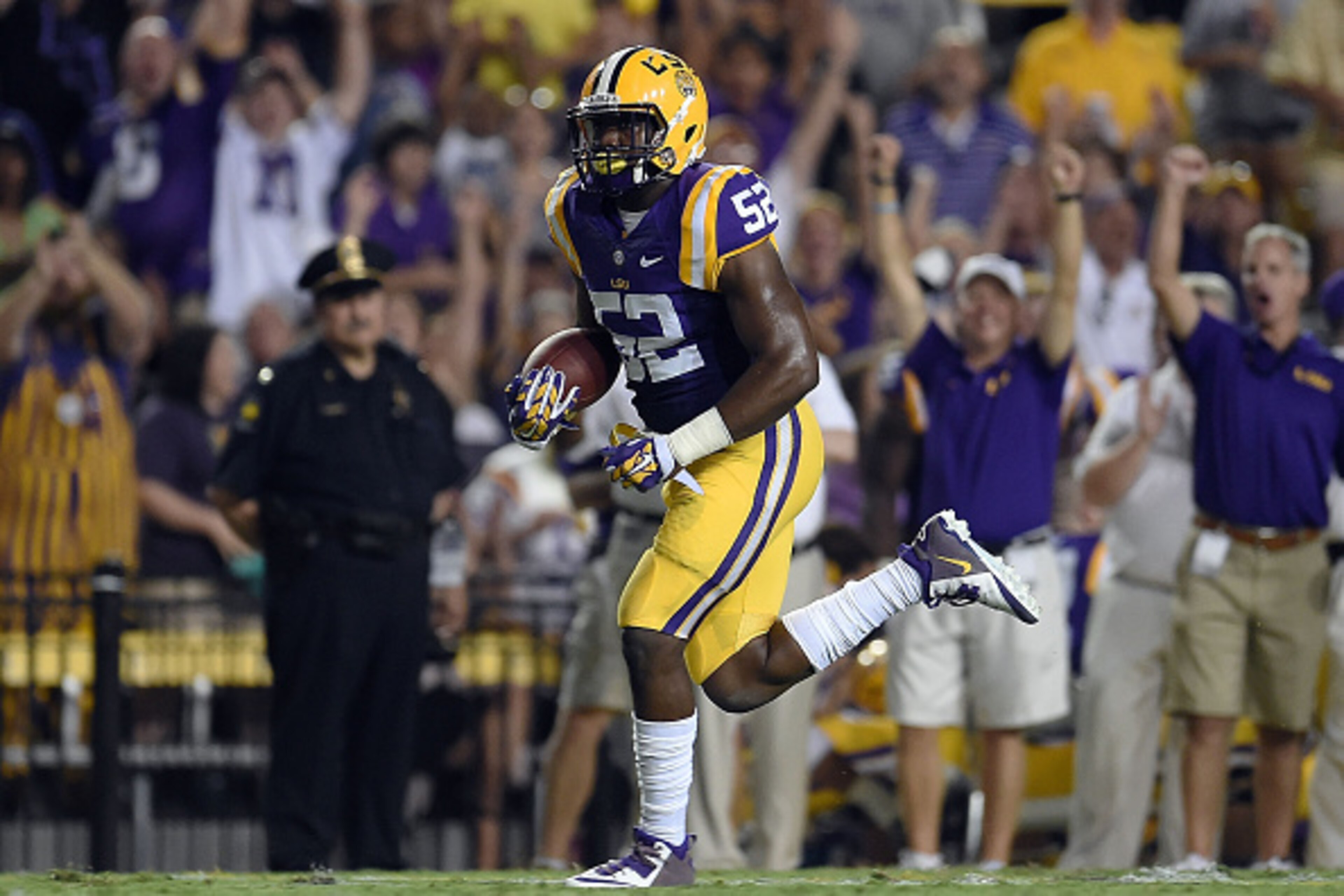BATON ROUGE, LA - SEPTEMBER 27:  Kendell Beckwith #52 of the LSU Tigers runs for a touchdown following a turnover during the first quarter of a game against the New Mexico State Aggies at Tiger Stadium on September 27, 2014 in Baton Rouge, Louisiana.  (Ph