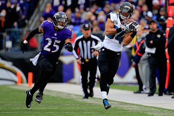 BALTIMORE, MD - DECEMBER 14: Wide receiver Cecil Shorts #84 of the Jacksonville Jaguars makes a second quarter catch over the defense of cornerback Asa Jackson #25 of the Baltimore Ravens at M&T Bank Stadium on December 14, 2014 in Baltimore, Maryland.  (