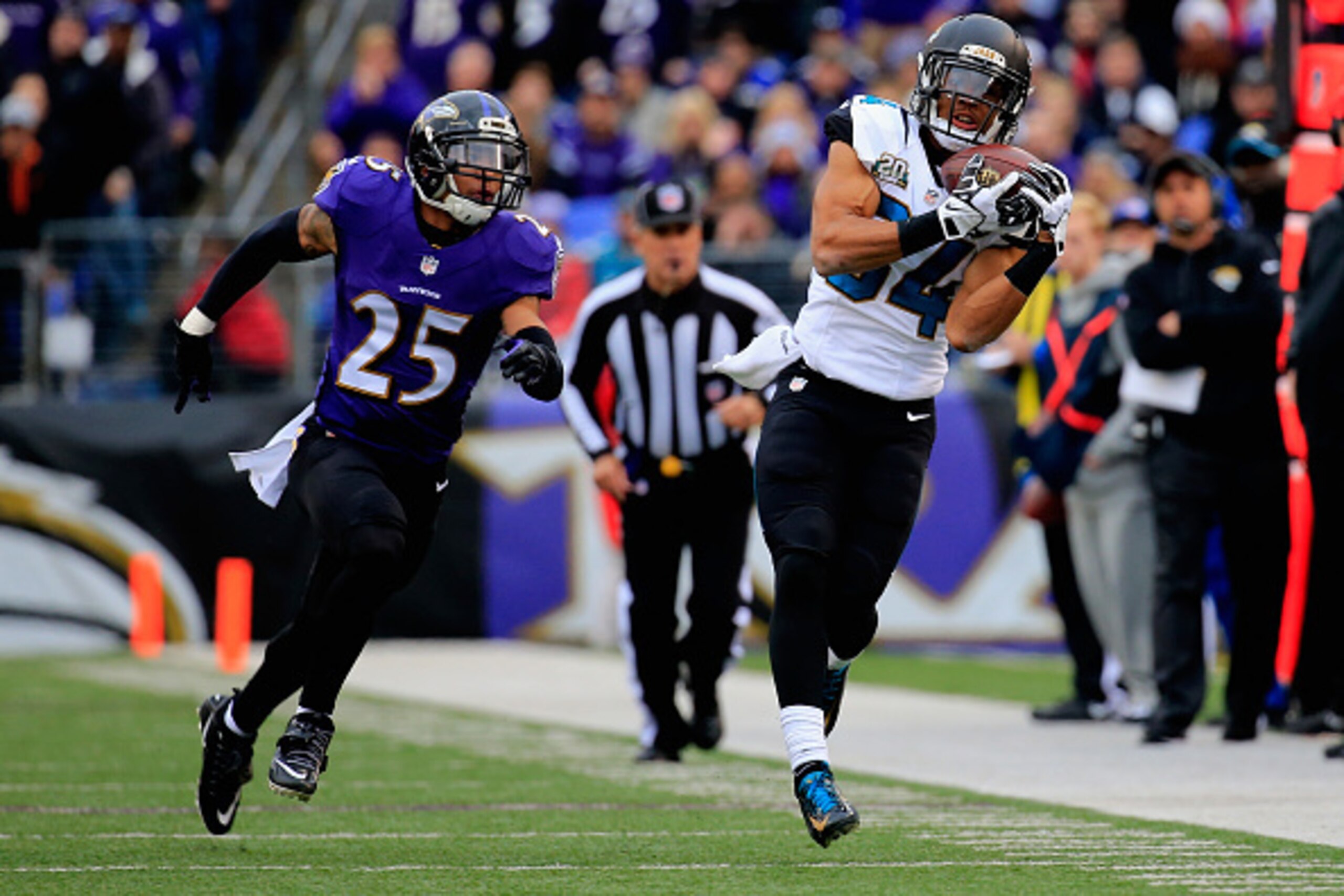 BALTIMORE, MD - DECEMBER 14: Wide receiver Cecil Shorts #84 of the Jacksonville Jaguars makes a second quarter catch over the defense of cornerback Asa Jackson #25 of the Baltimore Ravens at M&T Bank Stadium on December 14, 2014 in Baltimore, Maryland.  (