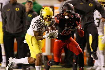 SALT LAKE CITY, UT - NOVEMBER 8:  defensive back Troy Hill #13 of the Oregon Ducks intercepts the ball from wide receiver Delshawn McClellon #10 of the Utah Utes during the second half of an NCAA football game November 8, 2014 at Rice-Eccles Stadium in Sa