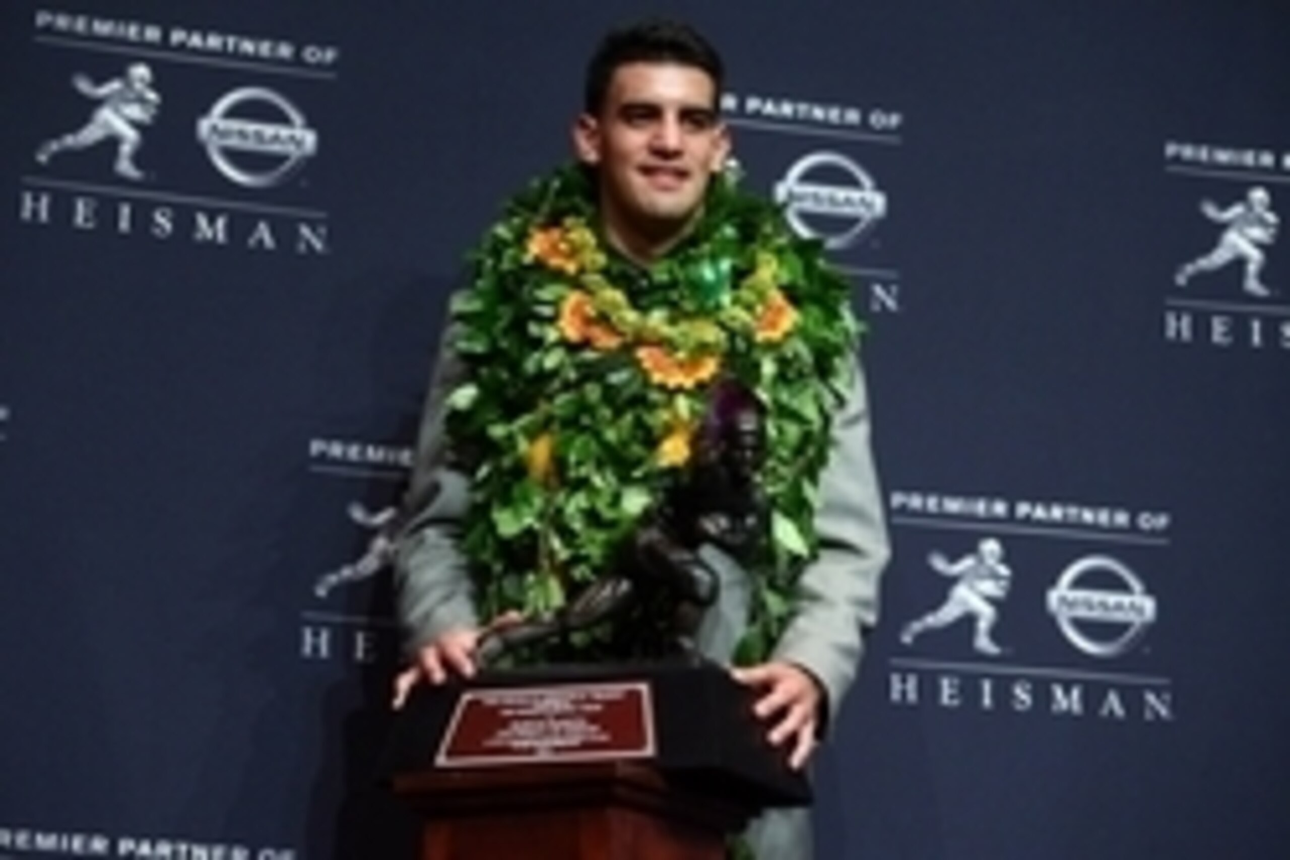 Dec 13, 2014; New  York, NY, USA; Oregon Ducks quarterback Marcus Mariota poses with the Heisman Trophy during a press conference at the New York Marriott Marquis after winning the Heisman Trophy. Mandatory Credit: Brad Penner-USA TODAY Sports