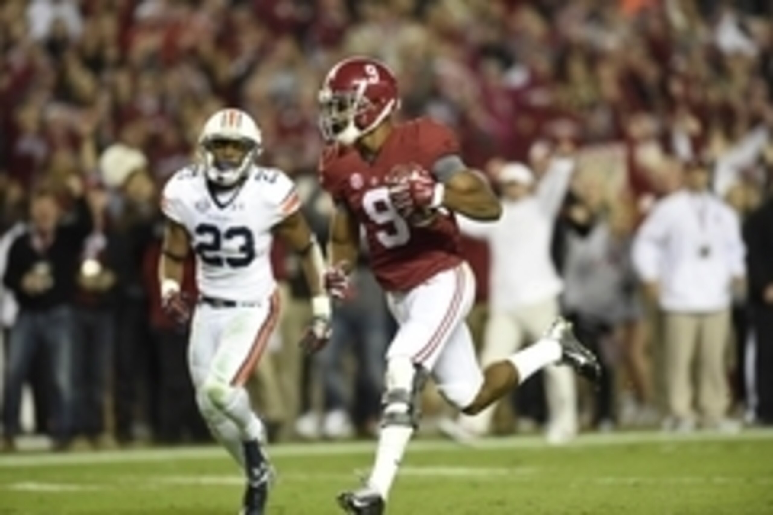 Nov 29, 2014; Tuscaloosa, AL, USA; Alabama Crimson Tide wide receiver Amari Cooper (9) catches a touchdown pass past Auburn Tigers defensive back Johnathan Ford (23) in the third quarter at Bryant-Denny Stadium. Mandatory Credit: John David Mercer-USA TOD