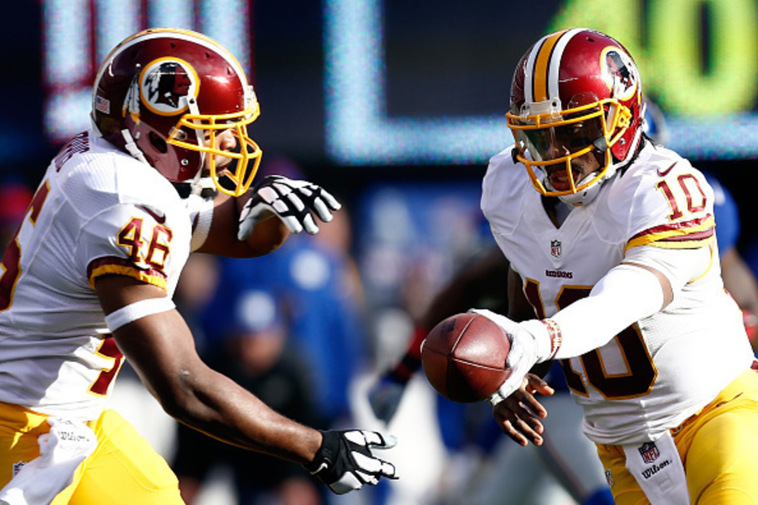EAST RUTHERFORD, NJ - DECEMBER 14:  Robert Griffin III #10 of the Washington Redskins hands the ball off to Alfred Morris #46 against the New York Giants during their game at MetLife Stadium on December 14, 2014 in East Rutherford, New Jersey.  (Photo by 