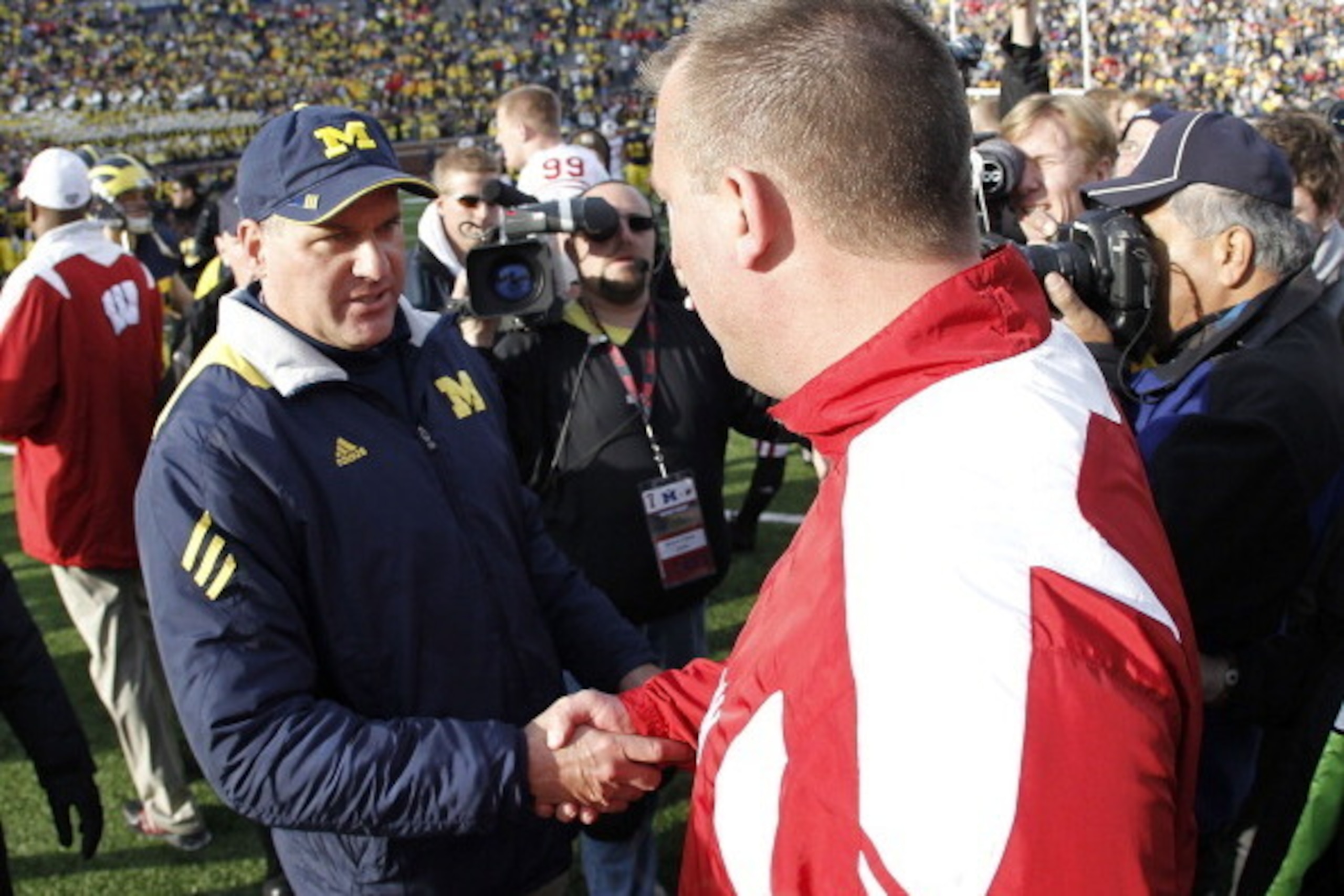 ANN ARBOR, MI - NOVEMBER 20:  Head coach Bret Bielema of the Wisconsin Badgers shakes hands after a 48-28 win with Head coach Rich Rodriguez of the Michigan Wolverines at Michigan Stadium on November 20, 2010 in Ann Arbor, Michigan.  (Photo by Gregory Sha