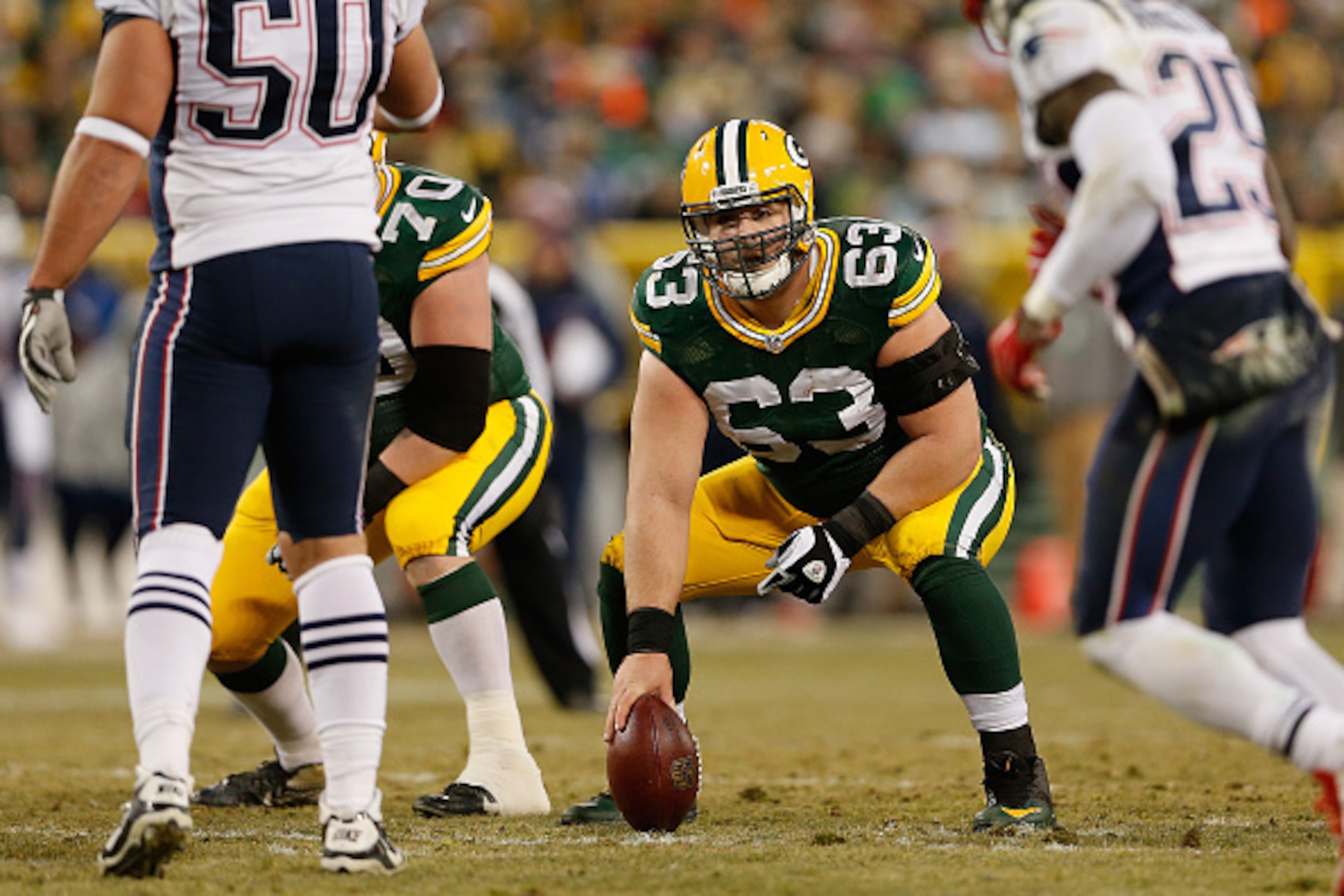 GREEN BAY, WI - NOVEMBER 30:  Center Corey Linsley #63 of the Green Bay Packers prepares to snap the football during the NFL game against the New England Patriots at Lambeau Field on November 30, 2014 in Green Bay, Wisconsin. The Packers defeated the Patr