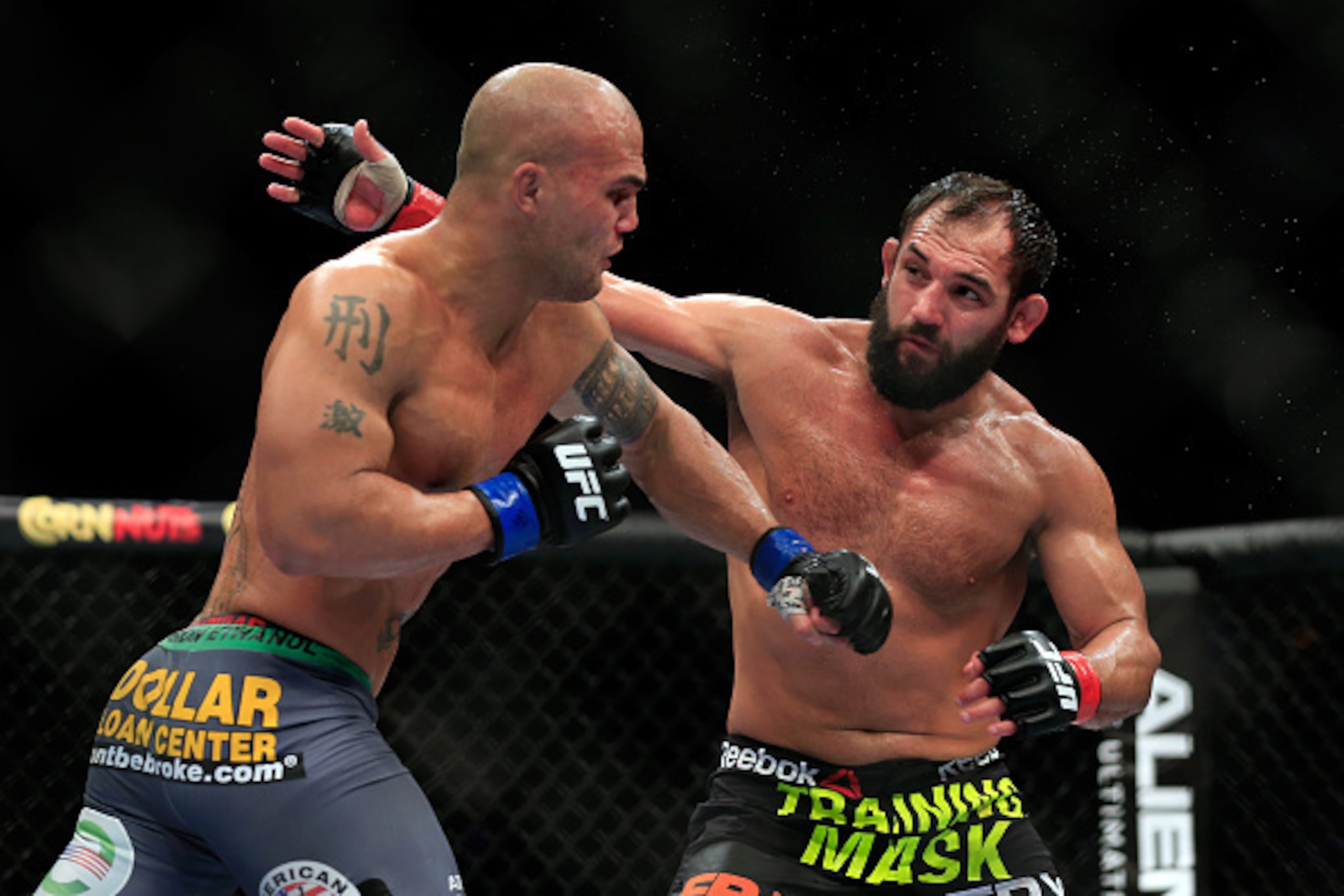 LAS VEGAS, NV - DECEMBER 06:  Robbie Lawler punches Johny Hendricks in their welterweight title fight during the UFC 181 event at the Mandalay Bay Events Center on December 6, 2014 in Las Vegas, Nevada.  (Photo by Alex Trautwig/Getty Images)
