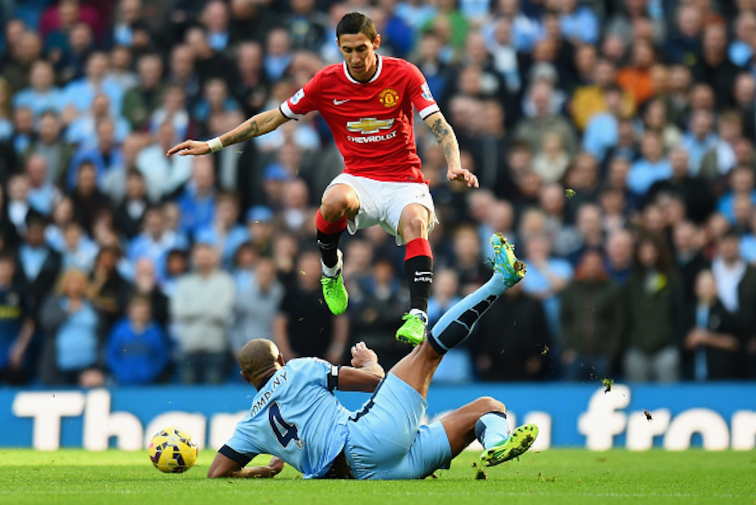 MANCHESTER, ENGLAND - NOVEMBER 02: Angel di Maria of Manchester United leaps over a challenge from Vincent Kompany of Manchester City during the Barclays Premier League match between Manchester City and Manchester United at Etihad Stadium on November 2, 2