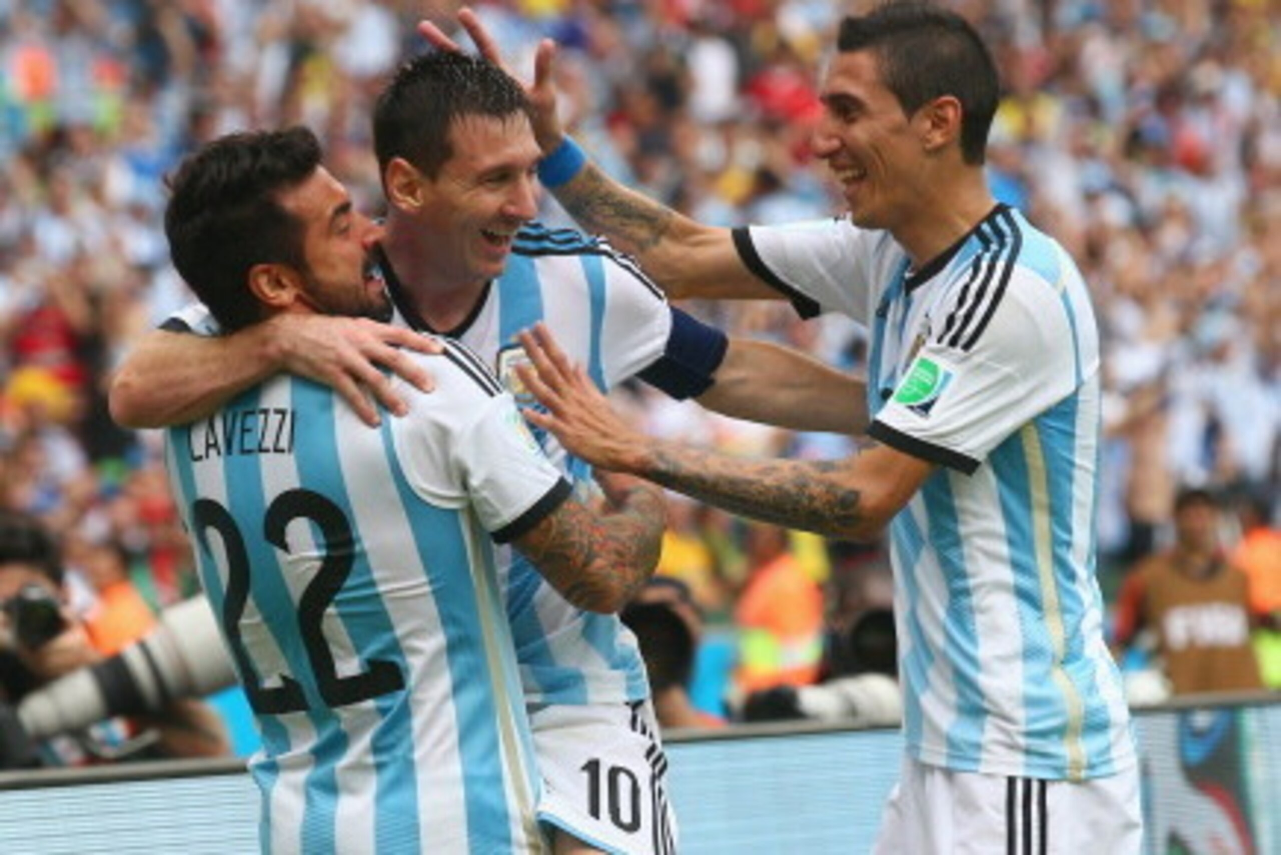 PORTO ALEGRE, BRAZIL - JUNE 25:  Lionel Messi of Argentina celebrates scoring his team's second goal and his second of the game with Ezequiel Lavezzi (L) and Angel di Maria (R) during the 2014 FIFA World Cup Brazil Group F match between Nigeria and Argent