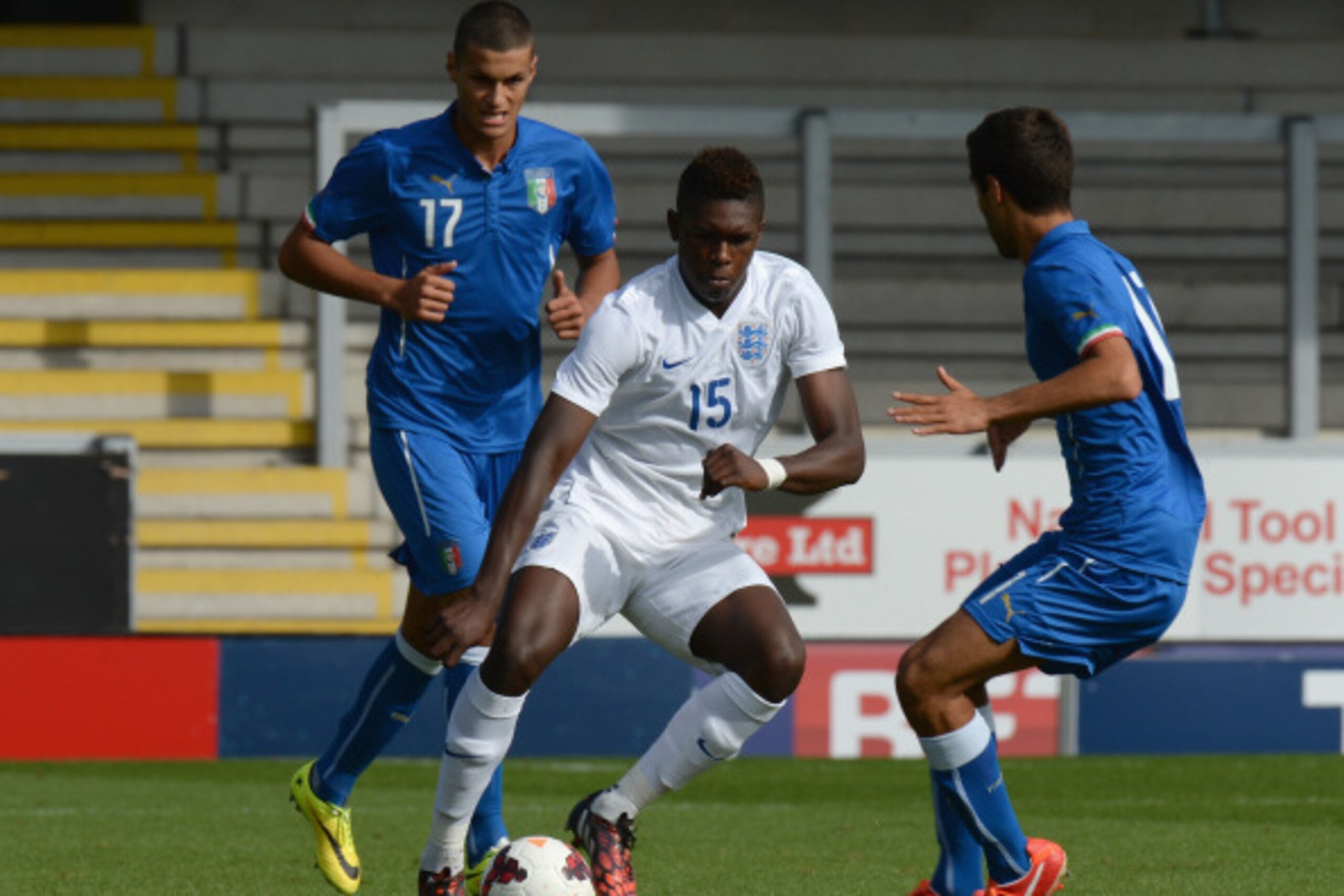 BURTON-UPON-TRENT, ENGLAND - AUGUST 31:  Darnell Johnson of England gets between Gianluca Scamacca and Matteo Gasperoni of Italy during the International match betweeen Engand Under 17 and Italy Under17 at Pirelli Stadium on August 31, 2014 in Burton-upon