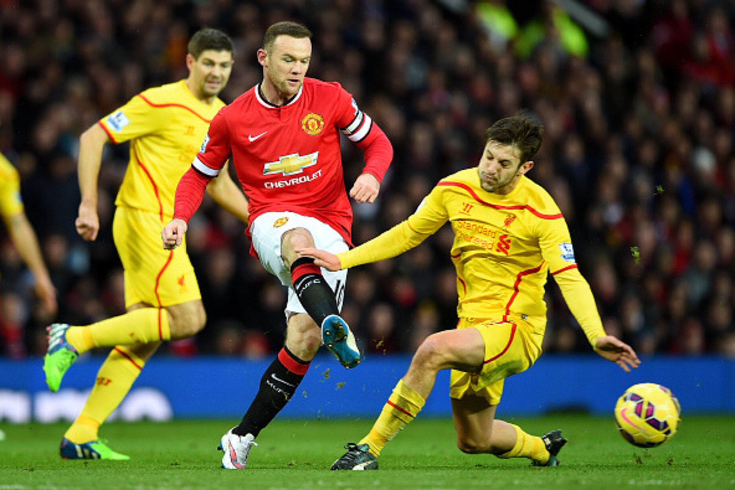 MANCHESTER, ENGLAND - DECEMBER 14:  Wayne Rooney of Manchester United competes with Adam Lallana of Liverpool during the Barclays Premier League match between Manchester United and Liverpool at Old Trafford on December 14, 2014 in Manchester, England.  (P