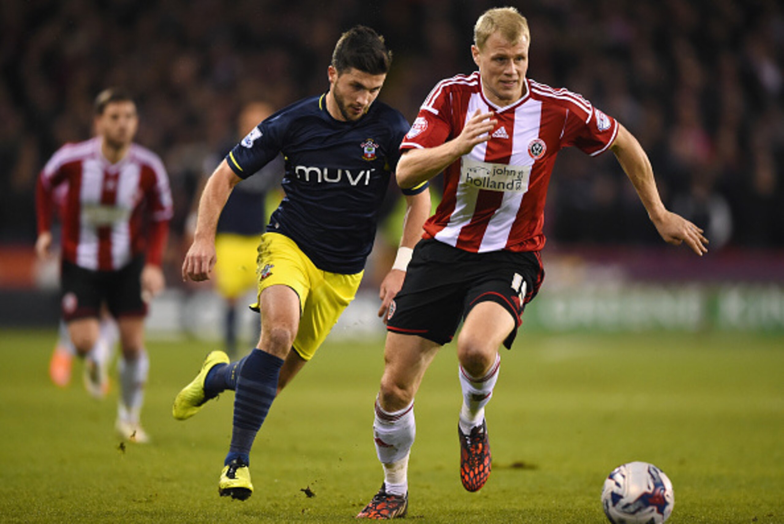 SHEFFIELD, ENGLAND - DECEMBER 16: James McEveley of Sheffield United is closed down by Shane Long of Southampton during the Capital One Cup Quarter-Final match between Sheffield United and Southampton at Bramall Lane on December 16, 2014 in Sheffield, Eng