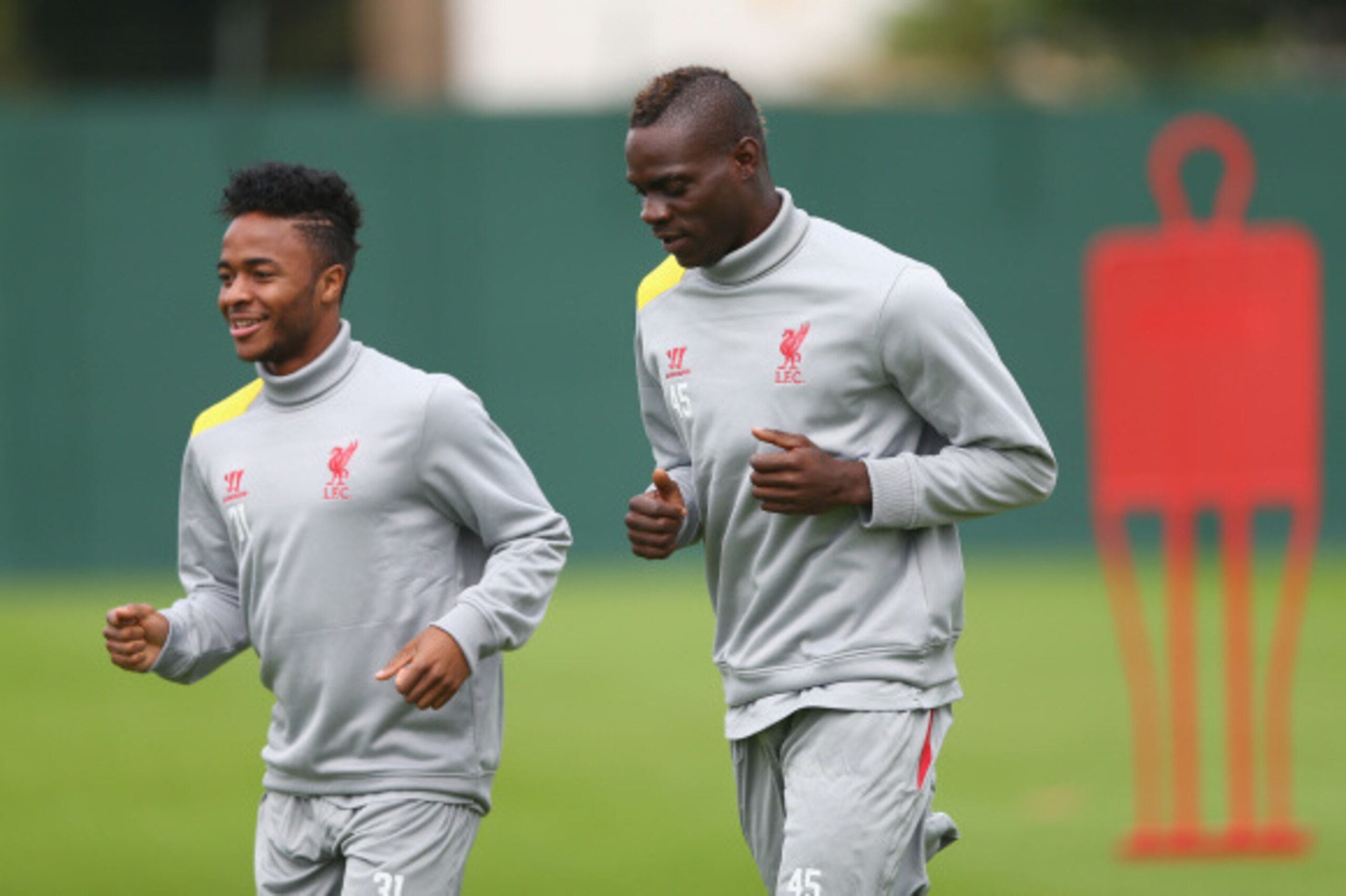 LIVERPOOL, ENGLAND - SEPTEMBER 15:  Mario Balotelli and team mate Raheem Sterling of Liverpool warm up for a during a training session ahead of their UEFA Champions League group B match against PFC Ludogorets on September 15, 2014 in Liverpool, United Kin