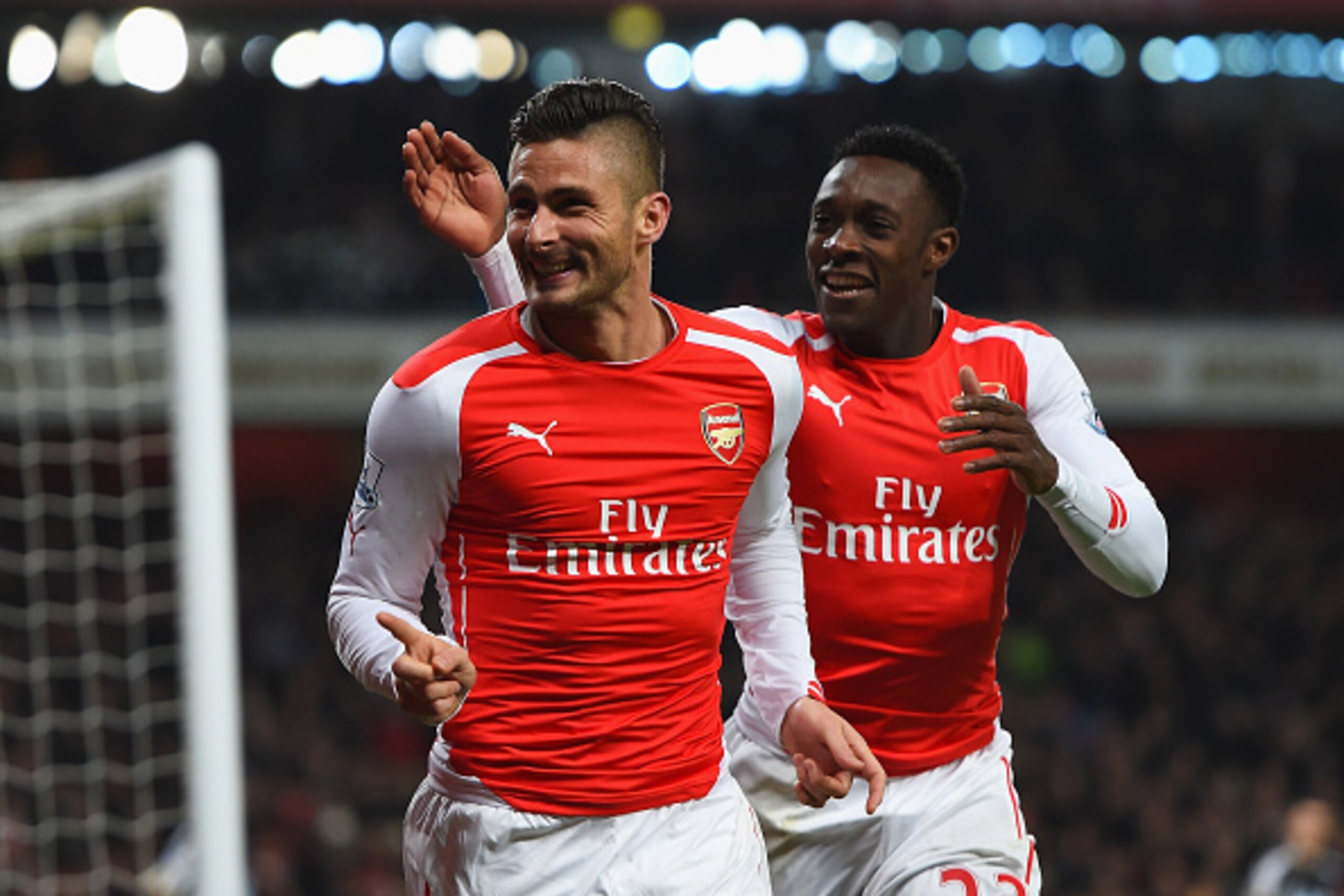 LONDON, ENGLAND - DECEMBER 13:  Olivier Giroud of Arsenal celebrates scoring his team's third goal with Danny Welbeck during the Barclays Premier League match between Arsenal and Newcastle United at Emirates Stadium on December 13, 2014 in London, England