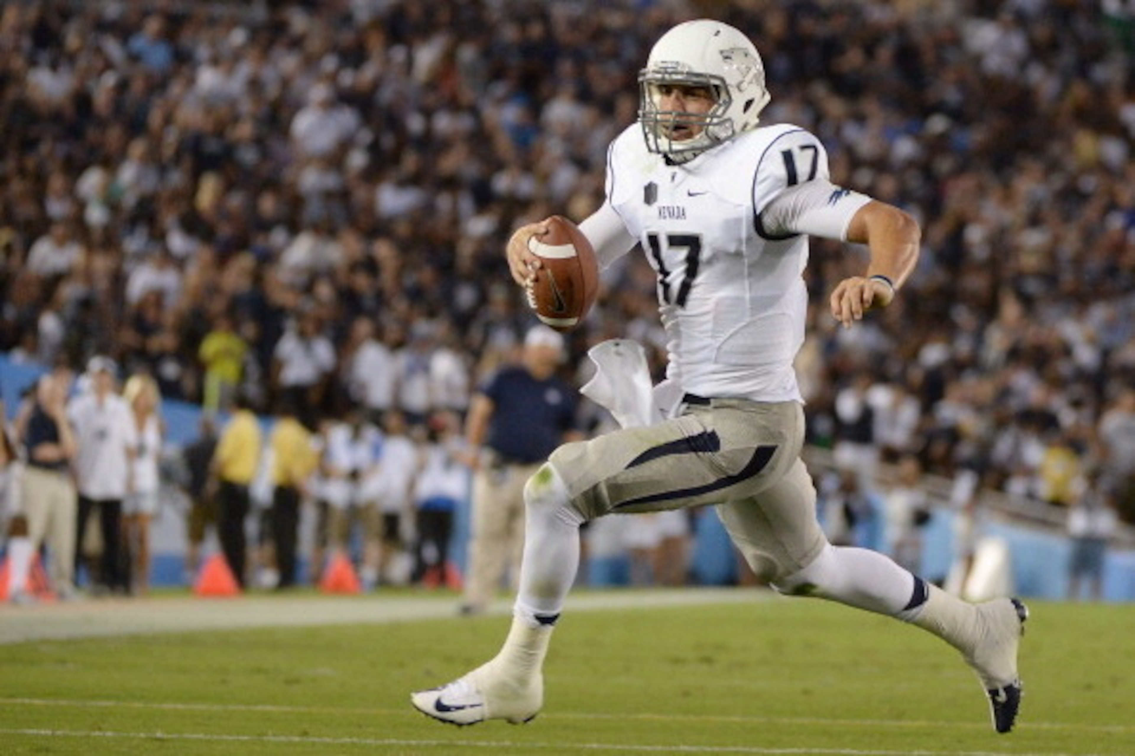 PASADENA, CA - AUGUST 31:  Cody Fajardo #17 of the Nevada Wolf Pack scrambles out of the pocket during the game against the UCLA Bruins at Rose Bowl on August 31, 2013 in Pasadena, California.  (Photo by Harry How/Getty Images)