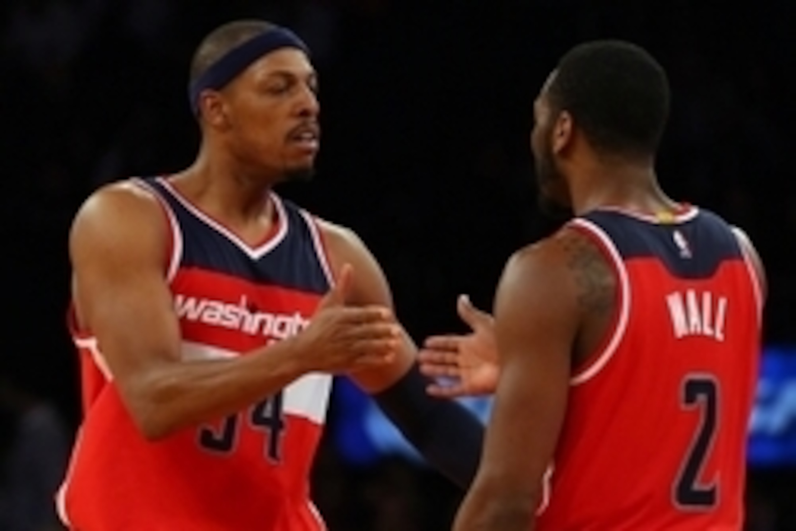 Nov 4, 2014; New York, NY, USA; Washington Wizards forward Paul Pierce (34) celebrates with guard John Wall (2) against the New York Knicks during the fourth quarter at Madison Square Garden. The Wizards defeated the Knicks 98-83. Mandatory Credit: Adam H