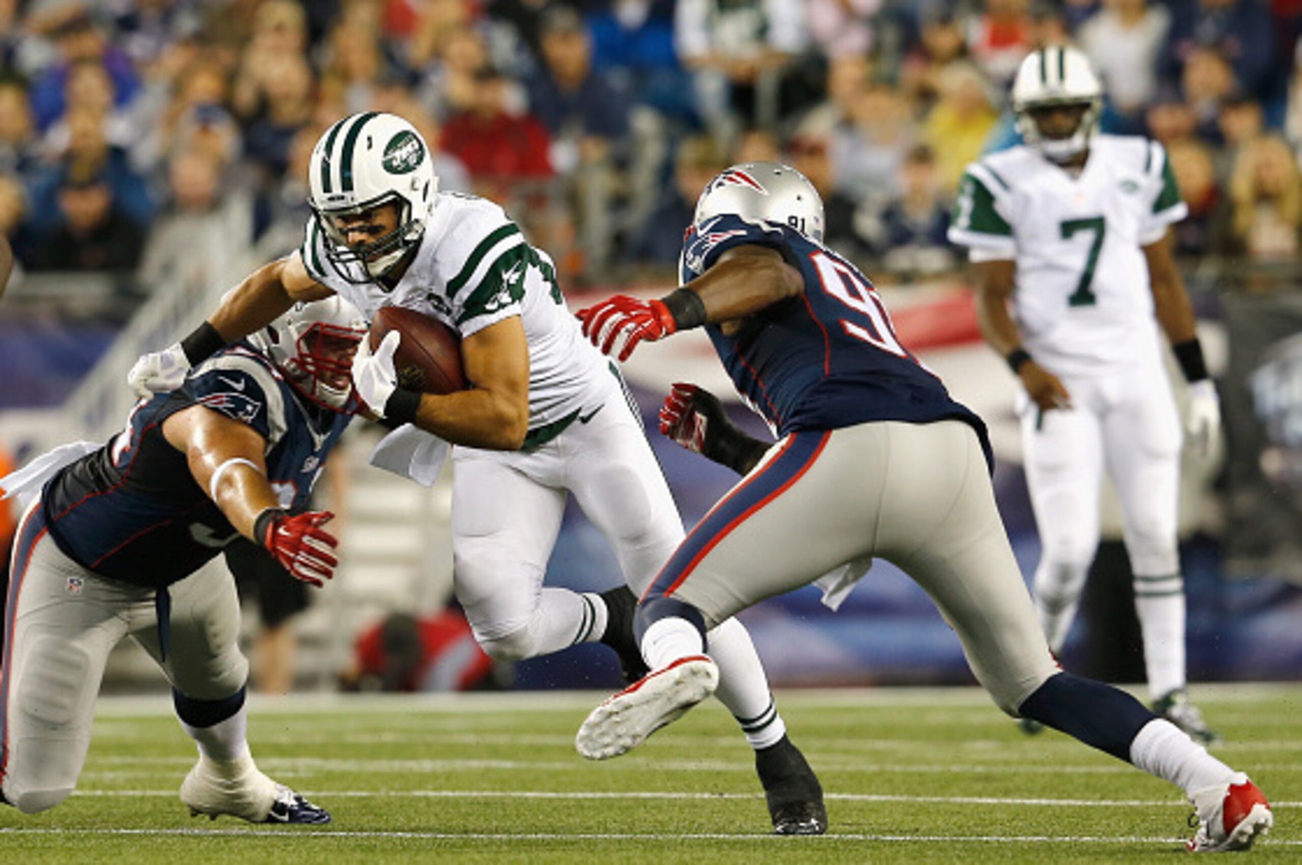 FOXBORO, MA - OCTOBER 16:  Eric Decker #87 of the New York Jets carries the ball after catching a pass during the first quarter against the New England Patriots at Gillette Stadium on October 16, 2014 in Foxboro, Massachusetts.  (Photo by Jim Rogash/Getty