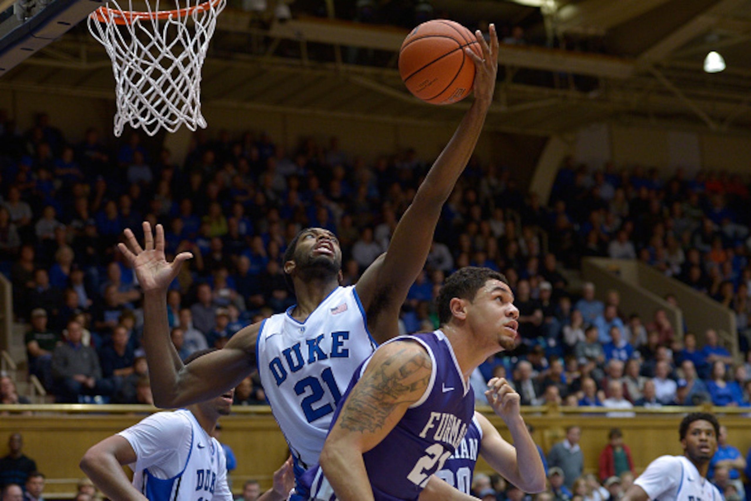DURHAM, NC - NOVEMBER 26: Amile Jefferson #21 of the Duke Blue Devils pulls down a rebound against the Furman Paladins during their game at Cameron Indoor Stadium on November 26, 2014 in Durham, North Carolina. Duke won 93-54. (Photo by Grant Halverson/Ge