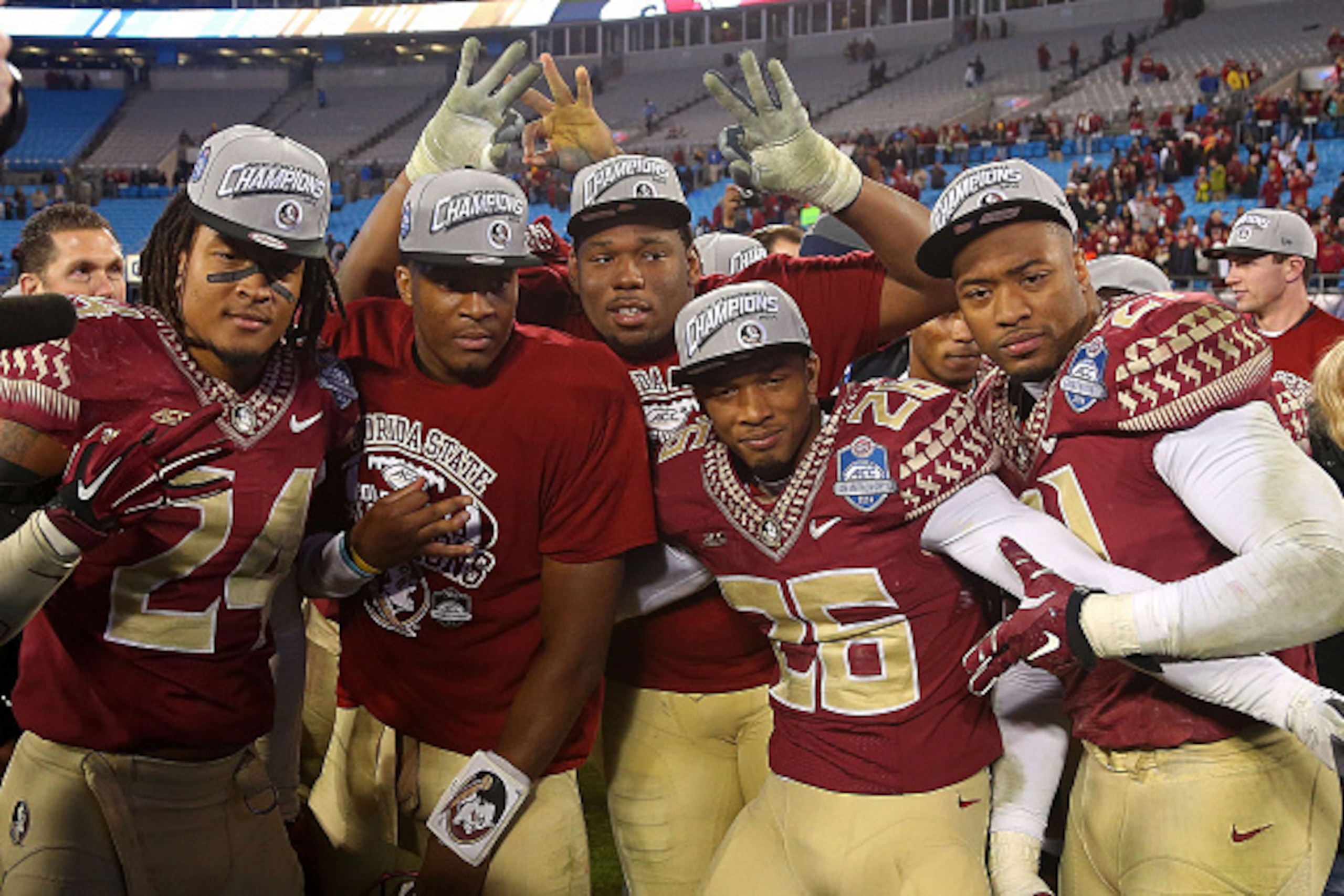 CHARLOTTE, NC - DECEMBER 06:  Matthew McNulty #24 , Jameis Winston #5 and P.J. Williams congratulate each other after their 37-35 victory over the Georgia Tech Yellow Jackets at the ACC Championship game on December 6, 2014 in Charlotte, North Carolina.  