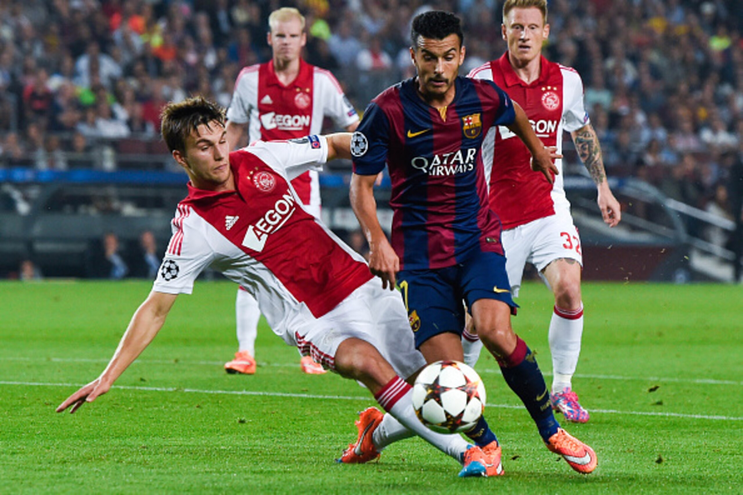 BARCELONA, SPAIN - OCTOBER 21: Pedro Rodriguez of FC Barcelona competes for the ball with Joel Veltman of AFC Ajax during a UEFA Champions League Group F match between FC Barcelona and AFC Ajax at the Camp Nou Stadium on October 21, 2014 in Barcelona, Spa BARCELONA, SPAIN - OCTOBER 21: Pedro Rodriguez of FC Barcelona competes for the ball with Joel Veltman of AFC Ajax during a UEFA Champions League Group F match between FC Barcelona and AFC Ajax at the Camp Nou Stadium on October 21, 2014 in Barcelona, Spa