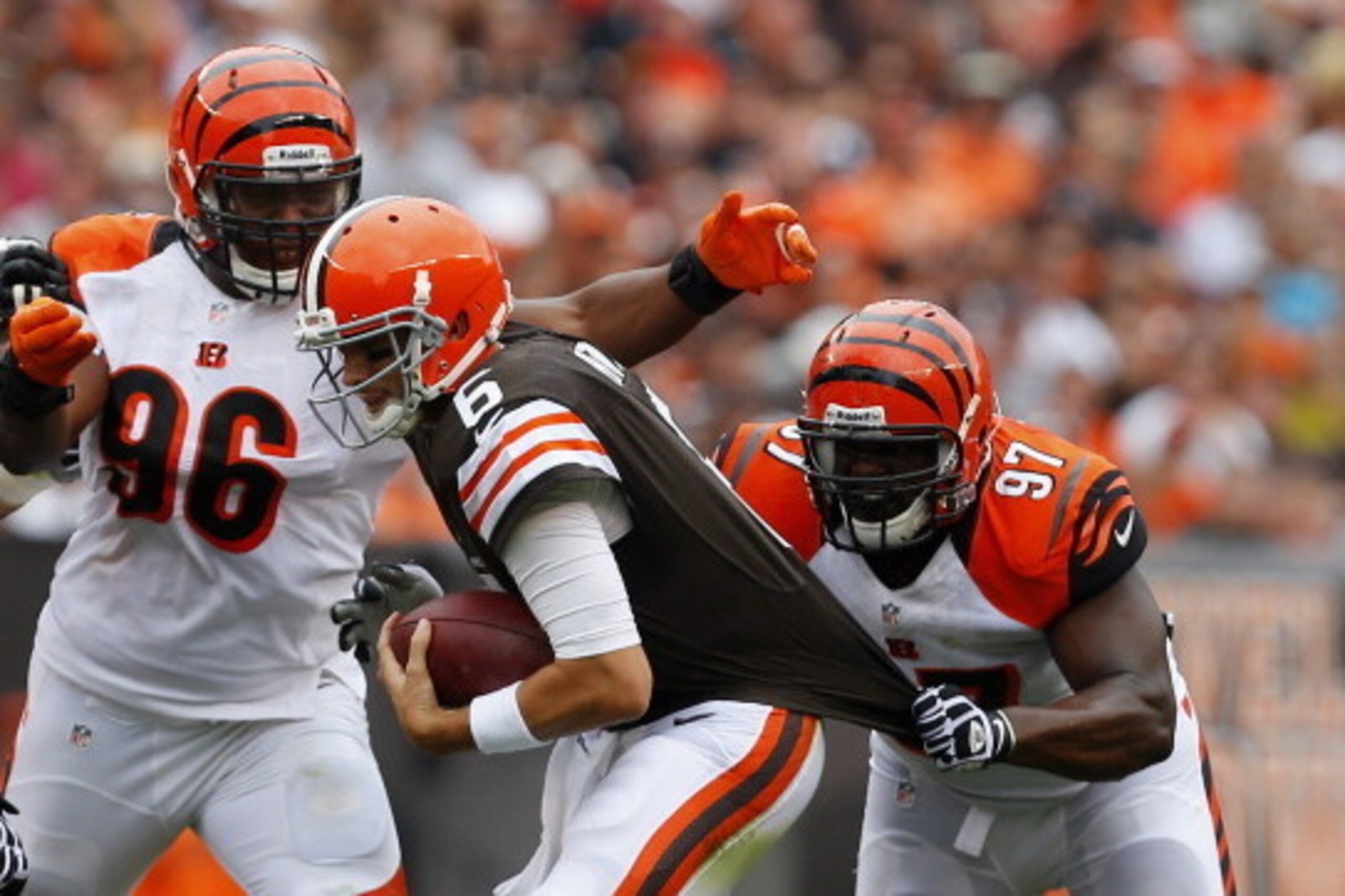 CLEVELAND, OH - SEPTEMBER 29:  Quarterback Brian  Hoyer #6 of the Cleveland Browns scrambles from defenders Carlos Dunlap #96 and Geno Atkins #97 the Cincinnati Bengals at FirstEnergy Stadium on September 29, 2013 in Cleveland, Ohio.  (Photo by Matt Sulli