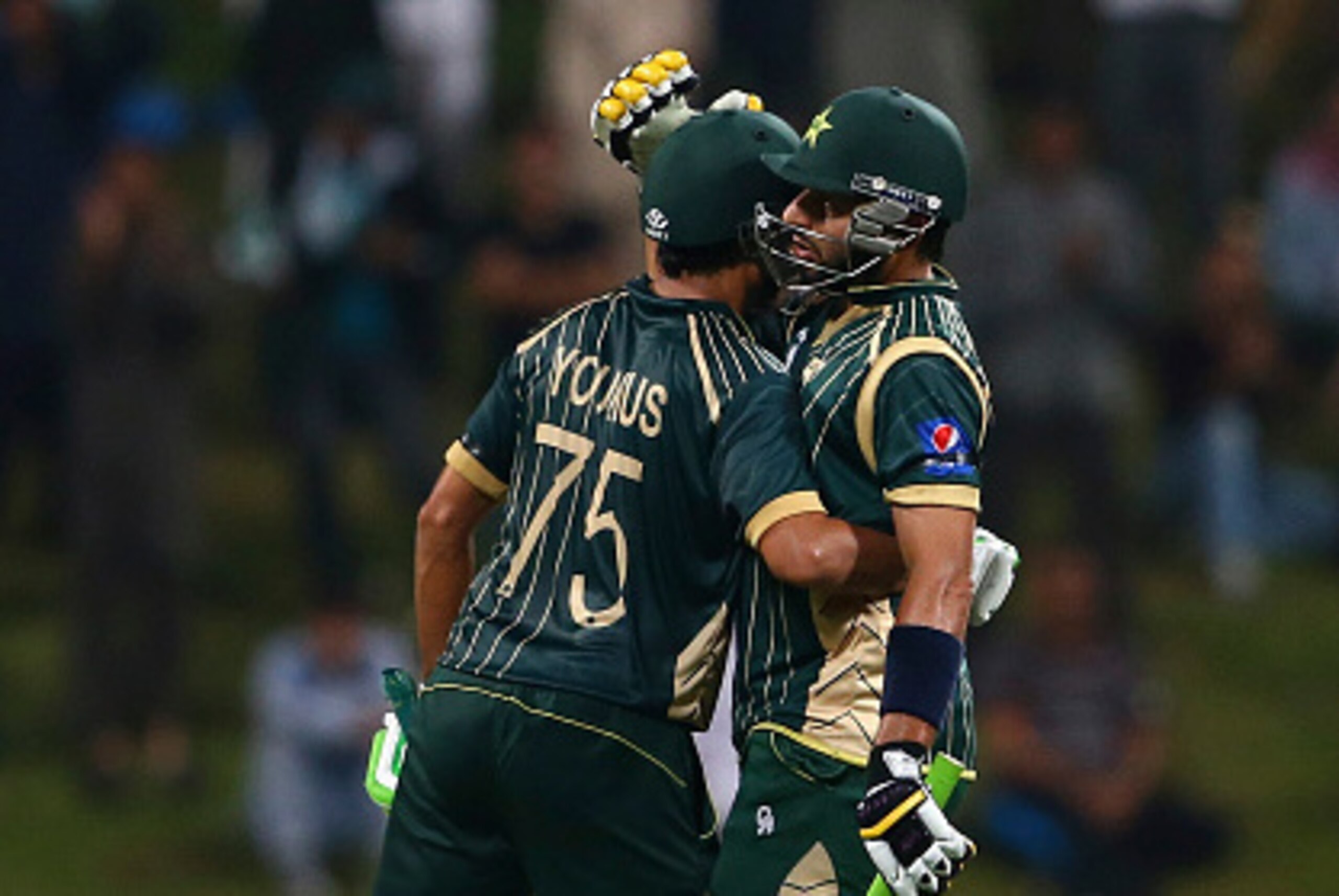ABU DHABI, UNITED ARAB EMIRATES - DECEMBER 17:  Younis Khan is congratulated by Shahid Afridi after reaching his century during the 4th One Day International match between Pakistan and New Zealand at Sheikh Zayed Stadium on December 17, 2014 in Abu Dhabi,