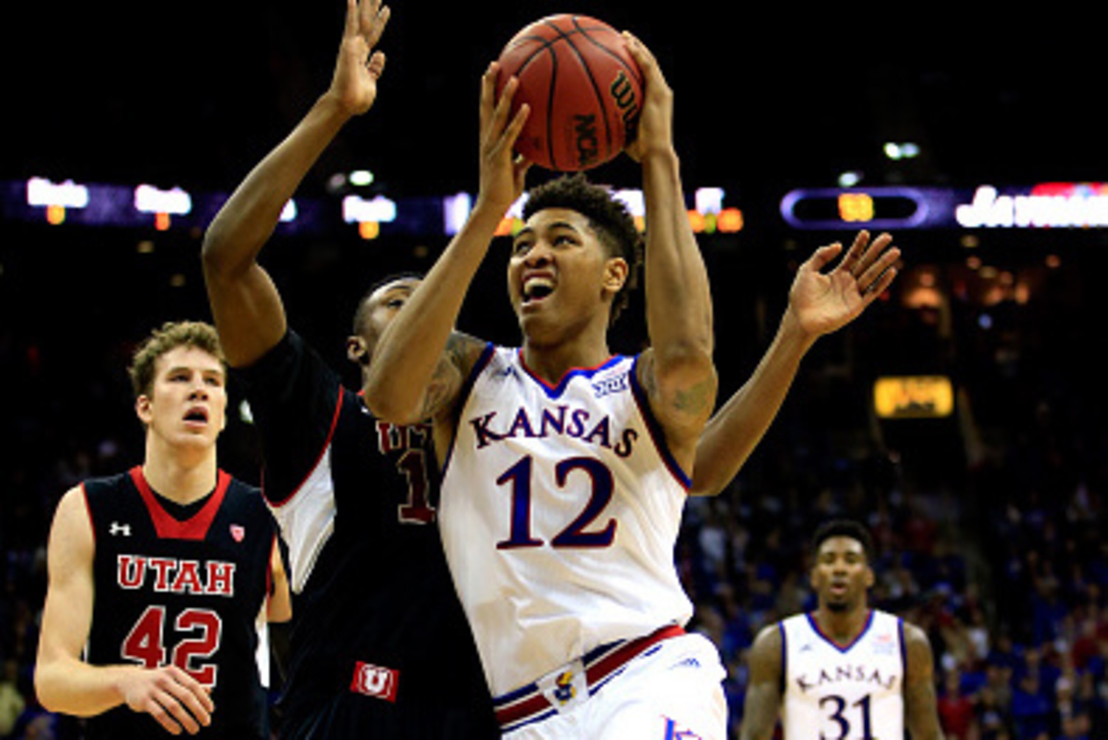 KANSAS CITY, MO - DECEMBER 13: Kelly Oubre Jr. #12 of the Kansas Jayhawks drives to the basket as Brandon Taylor #11 of the Utah Utes defends during the game at the Sprint Center on December 13, 2014 in Kansas City, Missouri. (Photo by Jamie Squire/Gett KANSAS CITY, MO - DECEMBER 13: Kelly Oubre Jr. #12 of the Kansas Jayhawks drives to the basket as Brandon Taylor #11 of the Utah Utes defends during the game at the Sprint Center on December 13, 2014 in Kansas City, Missouri. (Photo by Jamie Squire/Gett