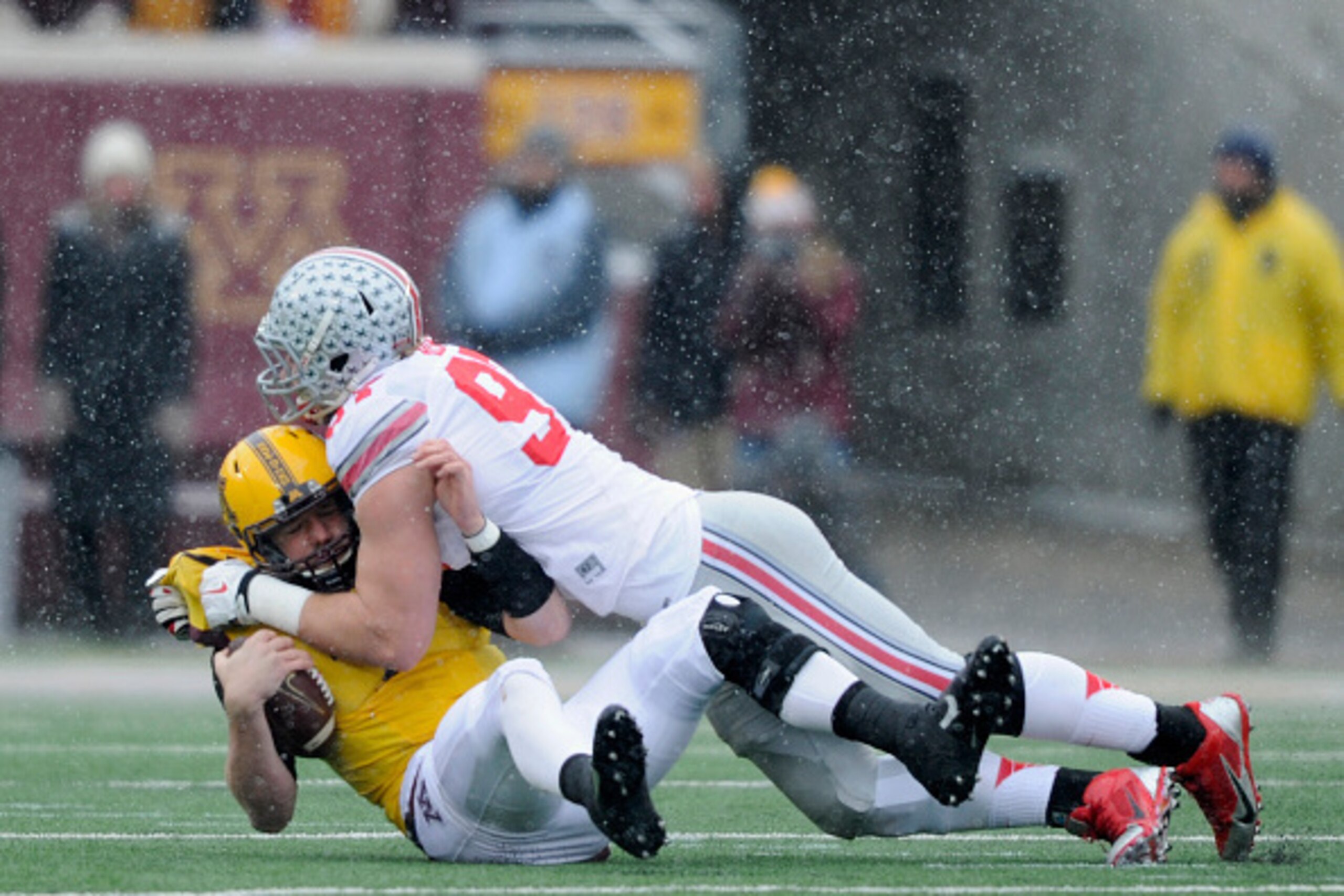MINNEAPOLIS, MN - NOVEMBER 15: Joey Bosa #97 of the Ohio State Buckeyes sacks Mitch Leidner #7 of the Minnesota Golden Gophers during the first quarter of the game on November 15, 2014 at TCF Bank Stadium in Minneapolis, Minnesota. (Photo by Hannah Foslie MINNEAPOLIS, MN - NOVEMBER 15: Joey Bosa #97 of the Ohio State Buckeyes sacks Mitch Leidner #7 of the Minnesota Golden Gophers during the first quarter of the game on November 15, 2014 at TCF Bank Stadium in Minneapolis, Minnesota. (Photo by Hannah Foslie
