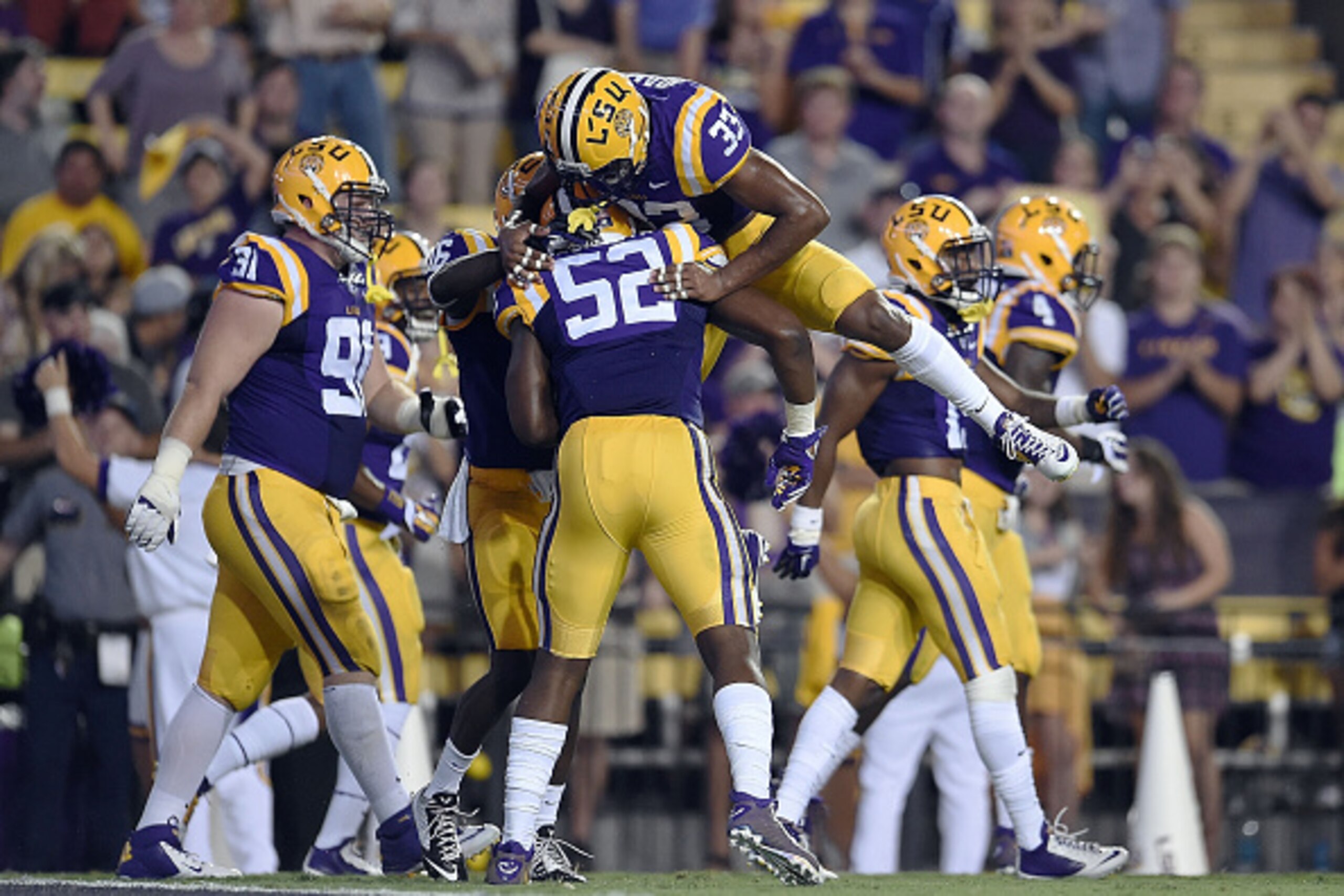 BATON ROUGE, LA - SEPTEMBER 27:  Jamal Adams #33 congratulates Kendell Beckwith #52 of the LSU Tigers following a defensive touchdown during the first quarter of a game against the New Mexico State Aggies at Tiger Stadium on September 27, 2014 in Baton Ro
