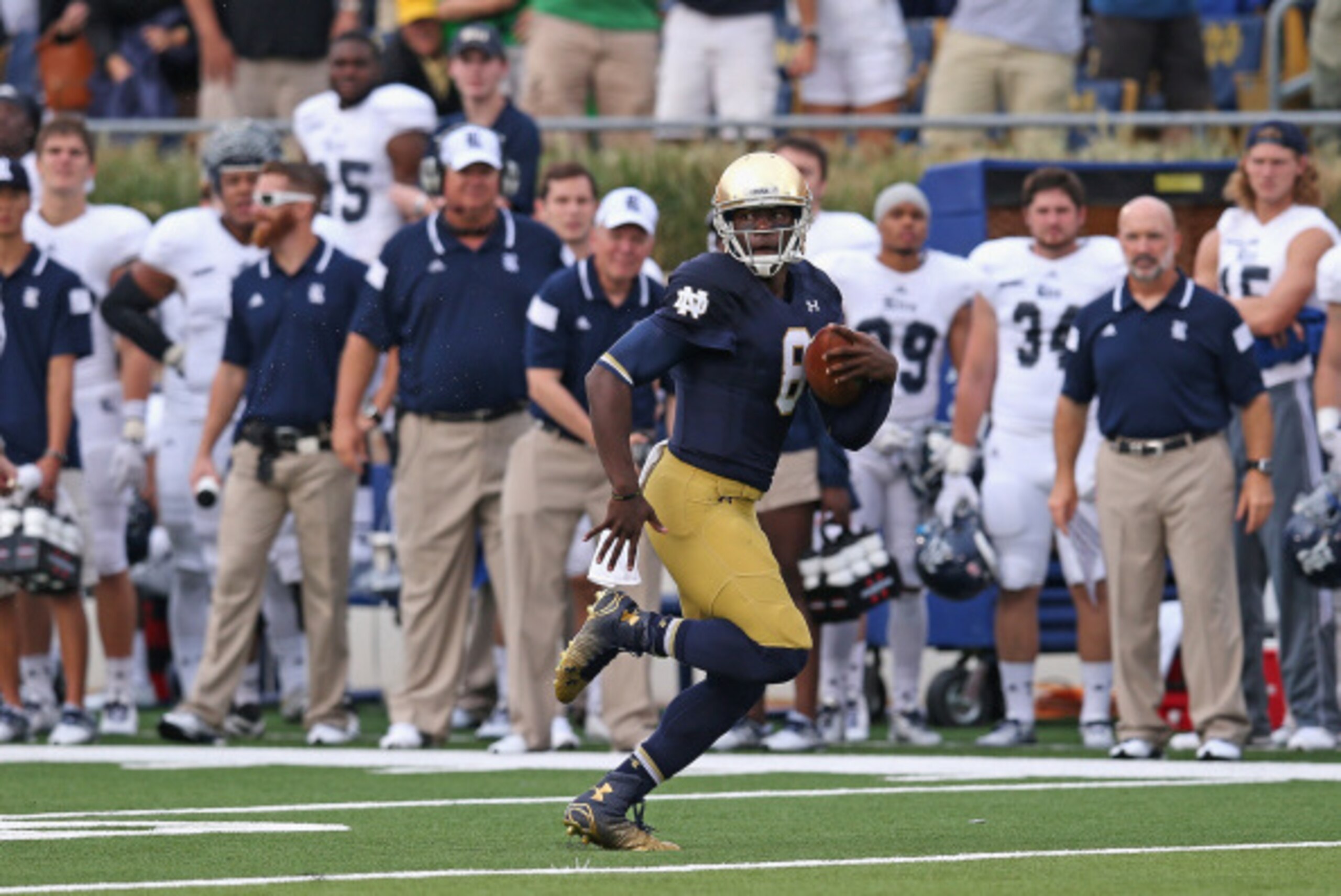 SOUTH BEND, IN - AUGUST 30:  Malik Zaire #8 of the Notre Dame Fighting Irish runs 56 yards on his very first collegiate play against the Rice Owls at Notre Dame Stadium on August 30, 2014 in South Bend, Indiana. Notre Dame defeated Rice 48-17.  (Photo by 