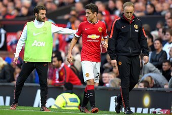 MANCHESTER, ENGLAND - SEPTEMBER 27:  Ander Herrera of Manchester United is consoled by teammate Juan Mata of Manchester United after being substituted in the second half during the Barclays Premier League match between Manchester United and West Ham Unite