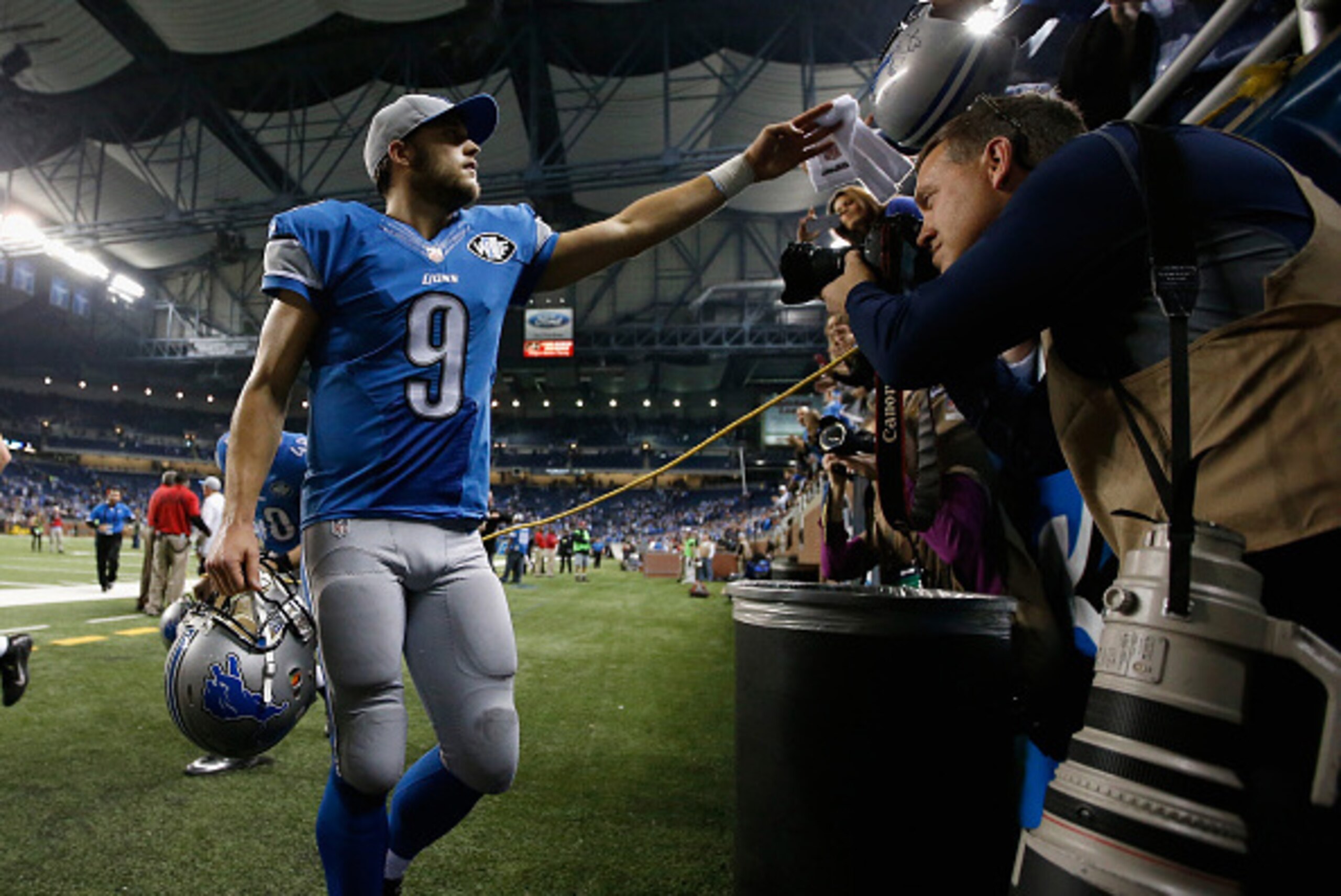 DETROIT, MI - DECEMBER 14: Matthew Stafford #9 of the Detroit Lions celebrates with fans as he walks off the field after beating the Minnesota Vikings 16-14 at Ford Field on December 14, 2014 in Detroit, Michigan. (Photo by Gregory Shamus/Getty Images)