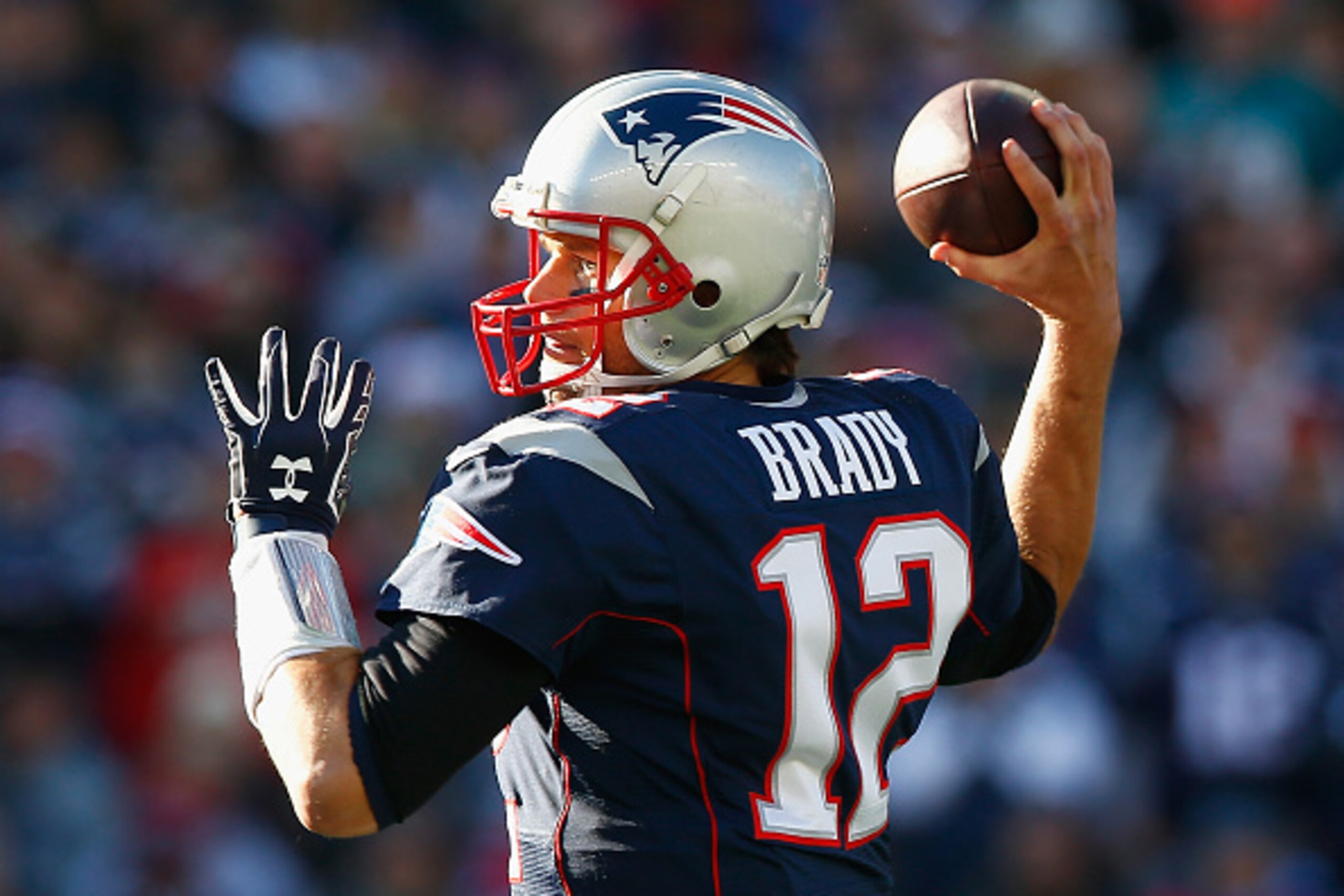 FOXBORO, MA - DECEMBER 14:  Tom Brady #12 of the New England Patriots passes the ball during the first quarter against the Miami Dolphins at Gillette Stadium on December 14, 2014 in Foxboro, Massachusetts.  (Photo by Jared Wickerham/Getty Images)