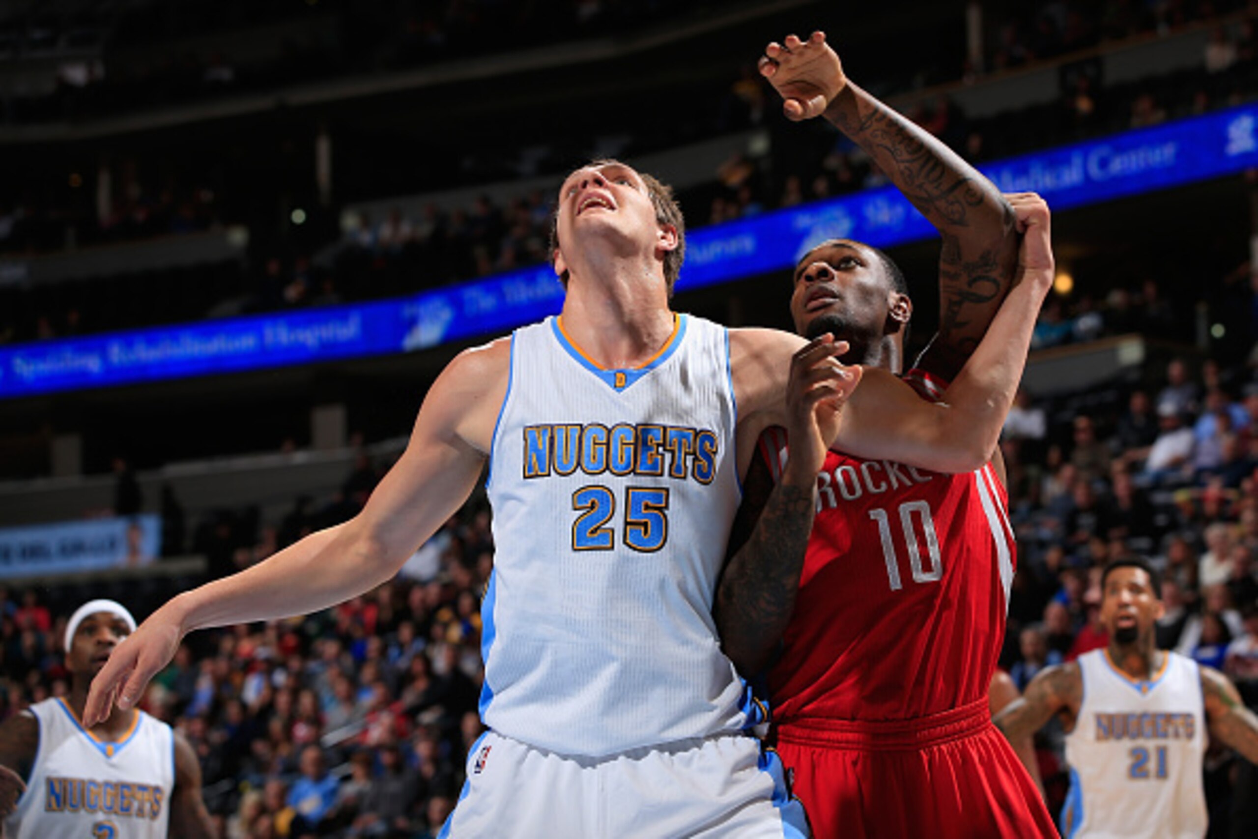 DENVER, CO - DECEMBER 17:  Timofey Mozgov #25 of the Denver Nuggets and Tarik Black #10 of the Houston Rockets battle for rebounding position at Pepsi Center on December 17, 2014 in Denver, Colorado. The Rockets defeated the Nuggets 115-111 in overtime. N