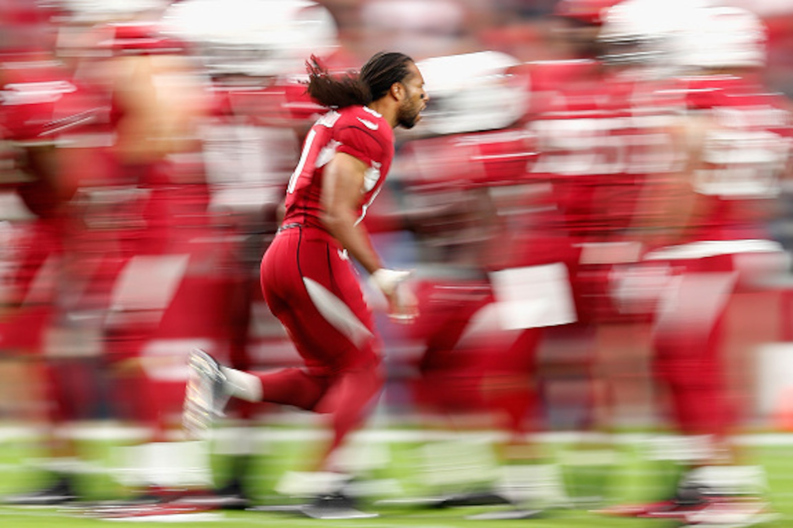 GLENDALE, AZ - DECEMBER 07:  Wide receiver Larry Fitzgerald #11 of the Arizona Cardinals high fives teammates as he is introduced to the NFL game against the Kansas City Chiefs at the University of Phoenix Stadium on December 7, 2014 in Glendale, Arizona.