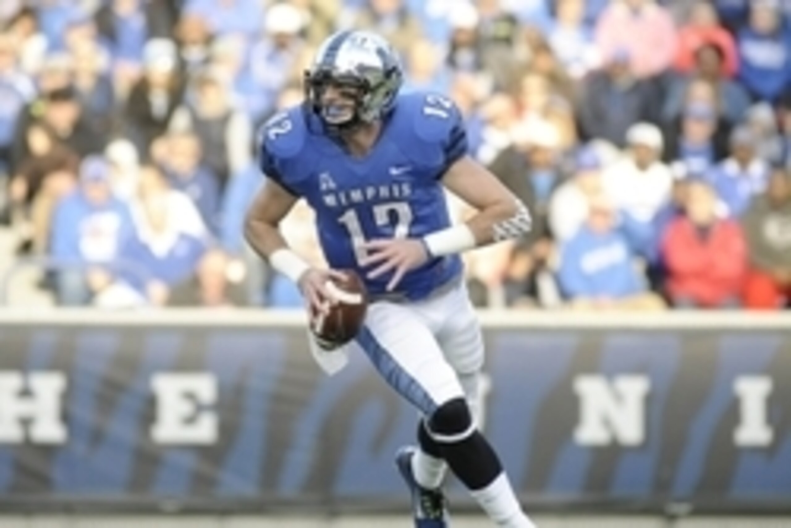 Nov 29, 2014; Memphis, TN, USA; Memphis Tigers quarterback Paxton Lynch (12) runs with the ball against the Connecticut Huskies during the game at Liberty Bowl Memorial Stadium. Mandatory Credit: Justin Ford-USA TODAY Sports