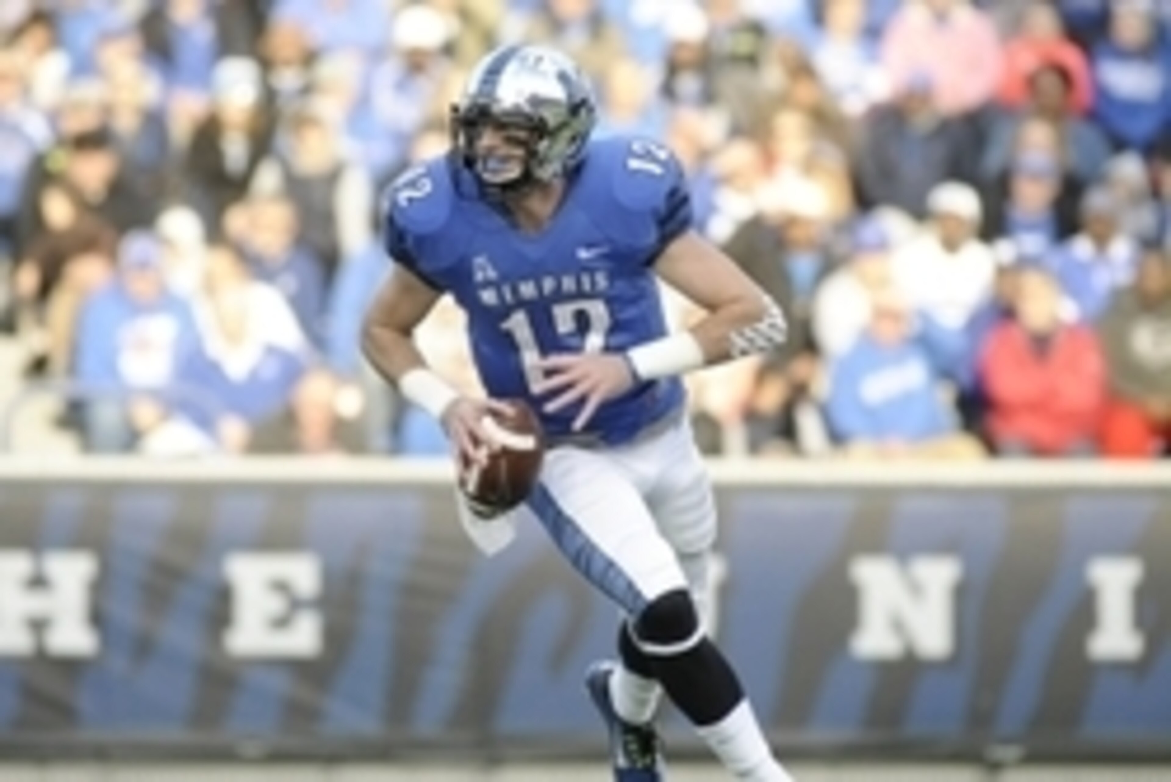 Nov 29, 2014; Memphis, TN, USA; Memphis Tigers quarterback Paxton Lynch (12) runs with the ball against the Connecticut Huskies during the game at Liberty Bowl Memorial Stadium. Mandatory Credit: Justin Ford-USA TODAY Sports