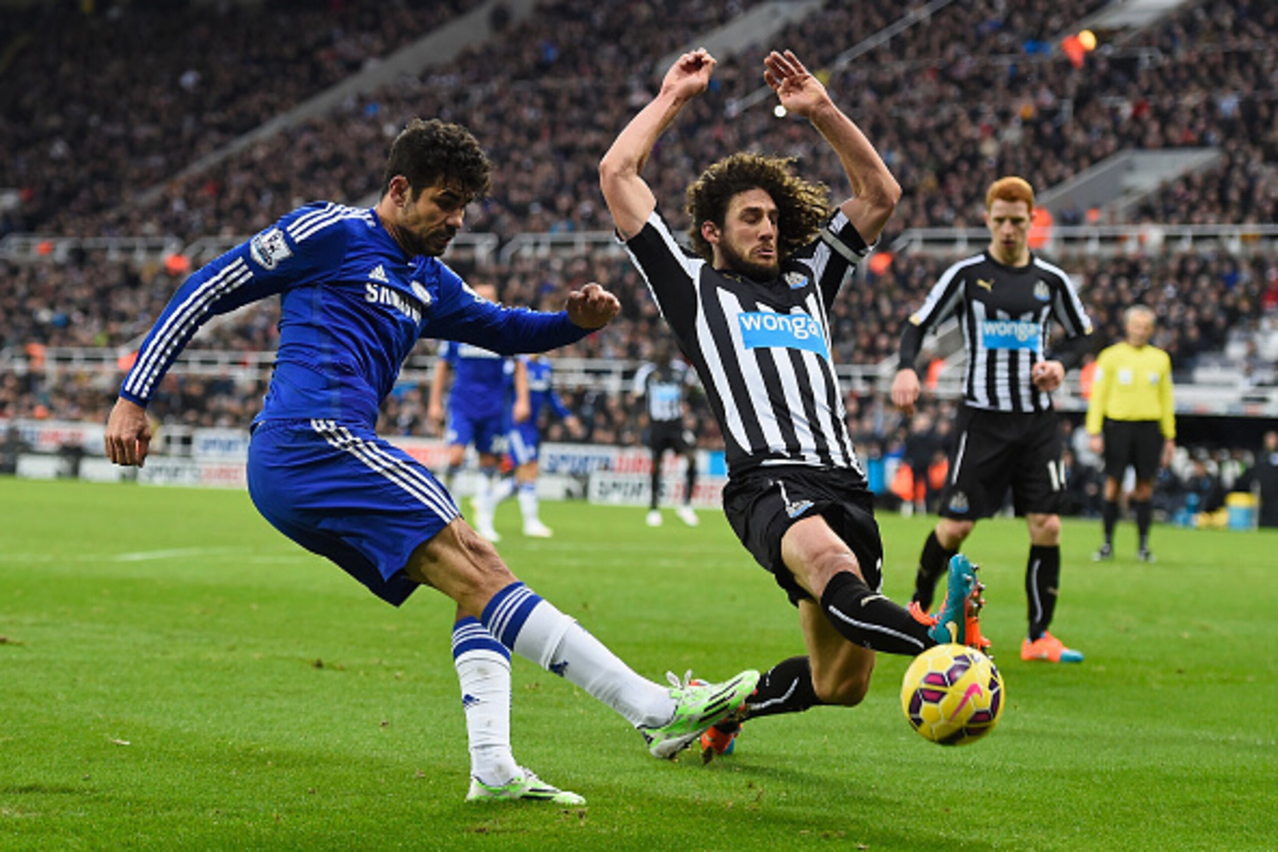 NEWCASTLE UPON TYNE, ENGLAND - DECEMBER 06:  Diego Costa of Chelsea  gets in a cross despite the efforts of Fabricio Coloccini of Newcastle during the Barclays Premier League match between Newcastle United and Chelsea at St James' Park on December 6, 2014