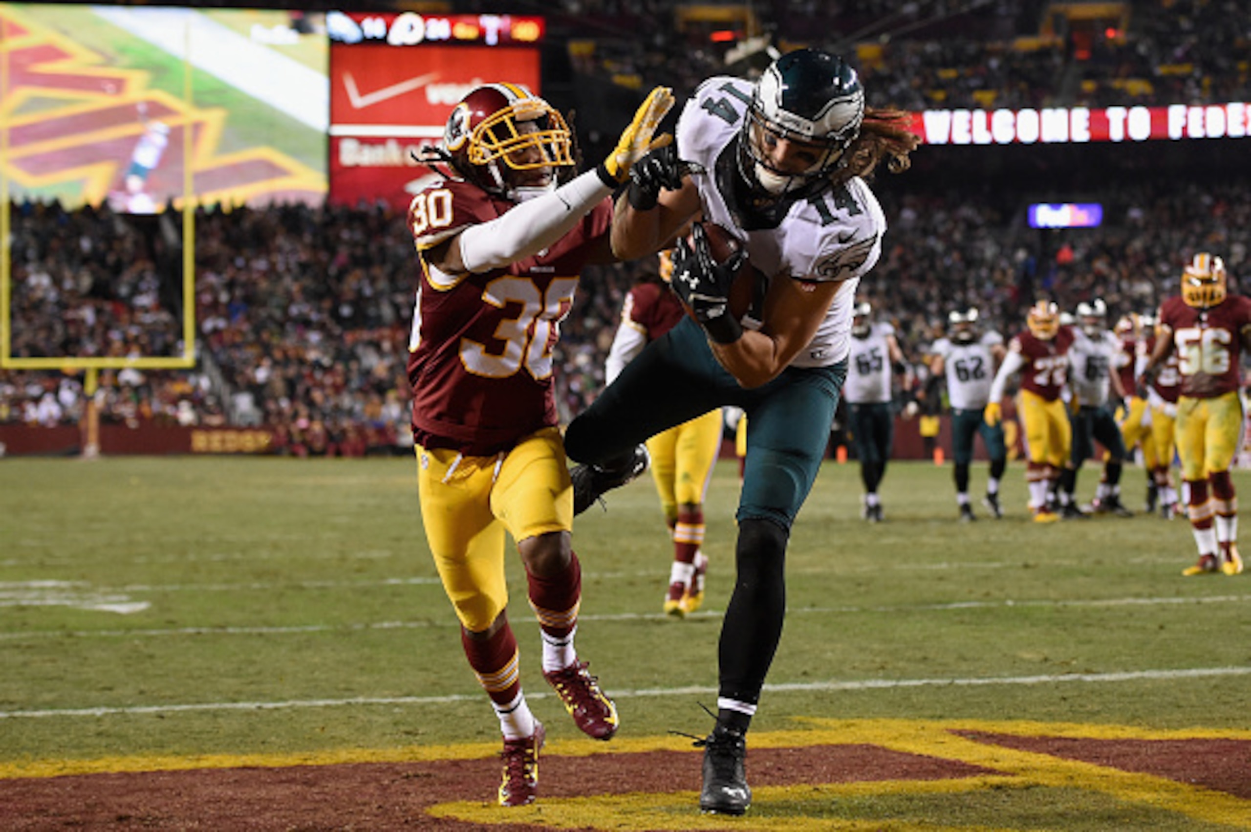 LANDOVER, MD - DECEMBER 20:  Wide receiver Riley Cooper #14 of the Philadelphia Eagles makes a fourth quarter touchdown catch over the defense of free safety E.J. Biggers #30 of the Washington Redskins at FedExField on December 20, 2014 in Landover, Maryl